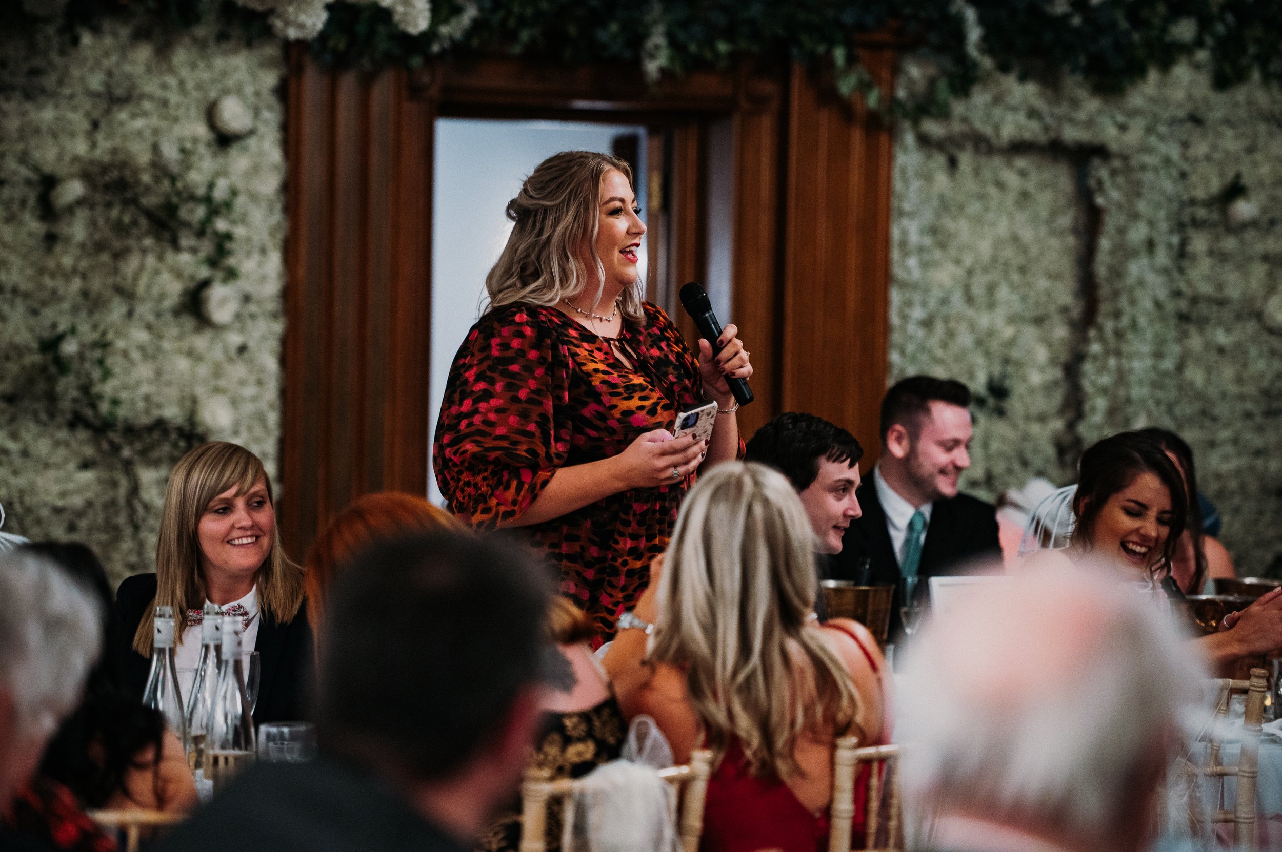 One of the guests standing up and sharing a slightly rude limerick that was written about the bride and groom.