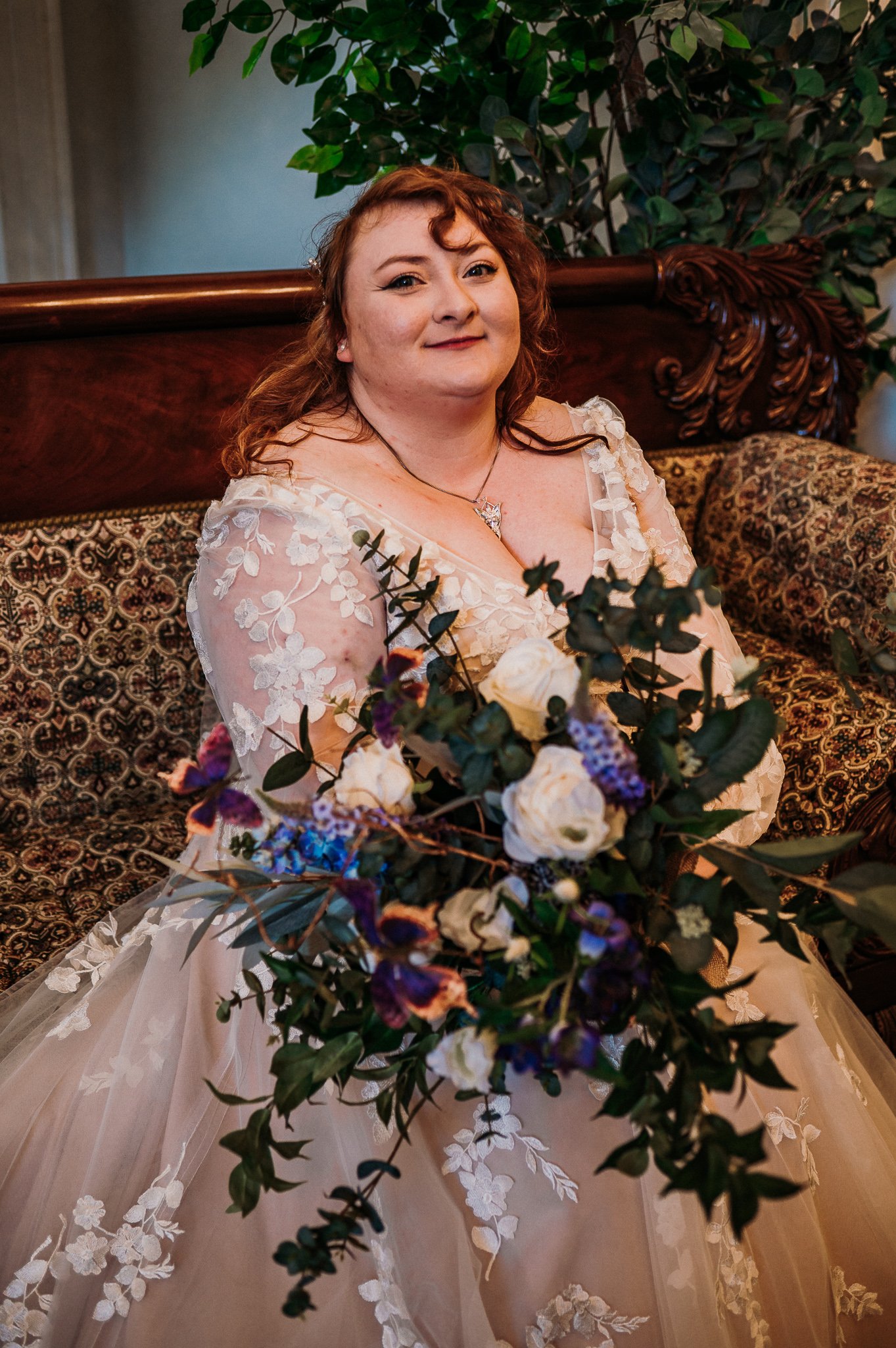 The bride sitting on a chaise longue on the morning of her wedding at Sneaton Castle, Whitby.