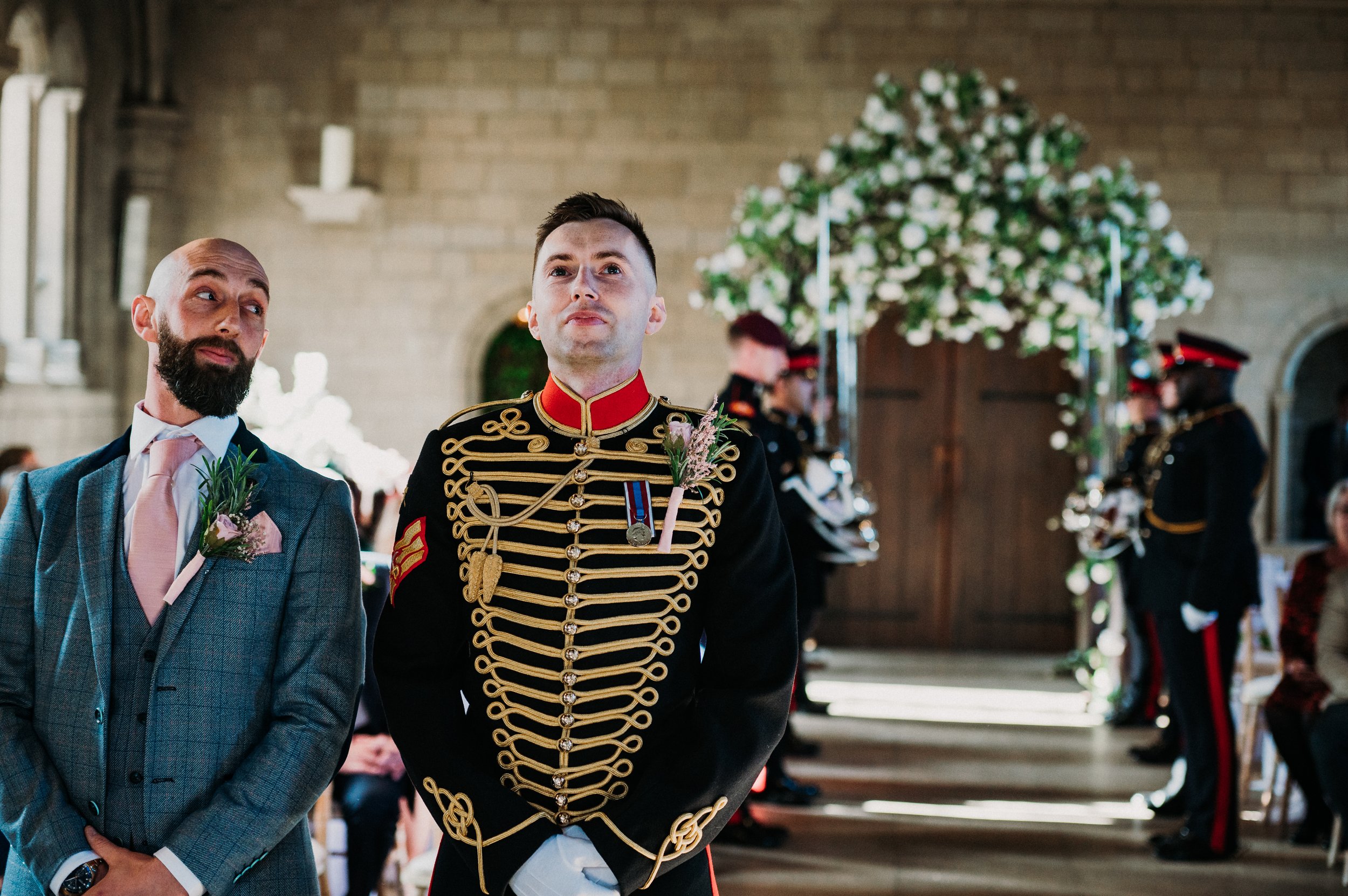 A nervous looking groom waits patiently for his bride to come into the ceremony room at Sneaton Castle, Whitby.