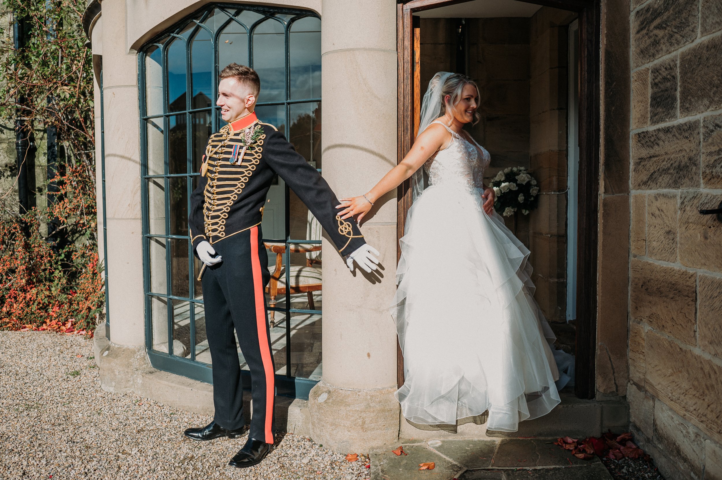 The bride and groom share their "first touch" around the corner at the castle whilst being careful not to catch a glimpse of each other before the ceremony.