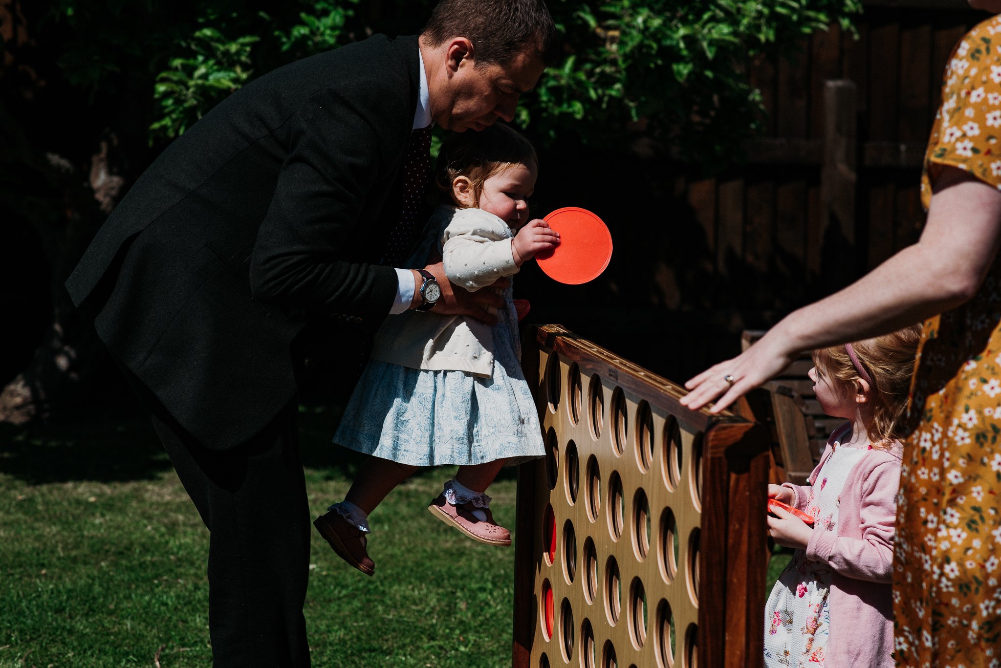 A wedding guest helps a young guest to win at giant Connect 4 during the lawn games after the wedding ceremony at Sneaton Castle, North Yorkshire.