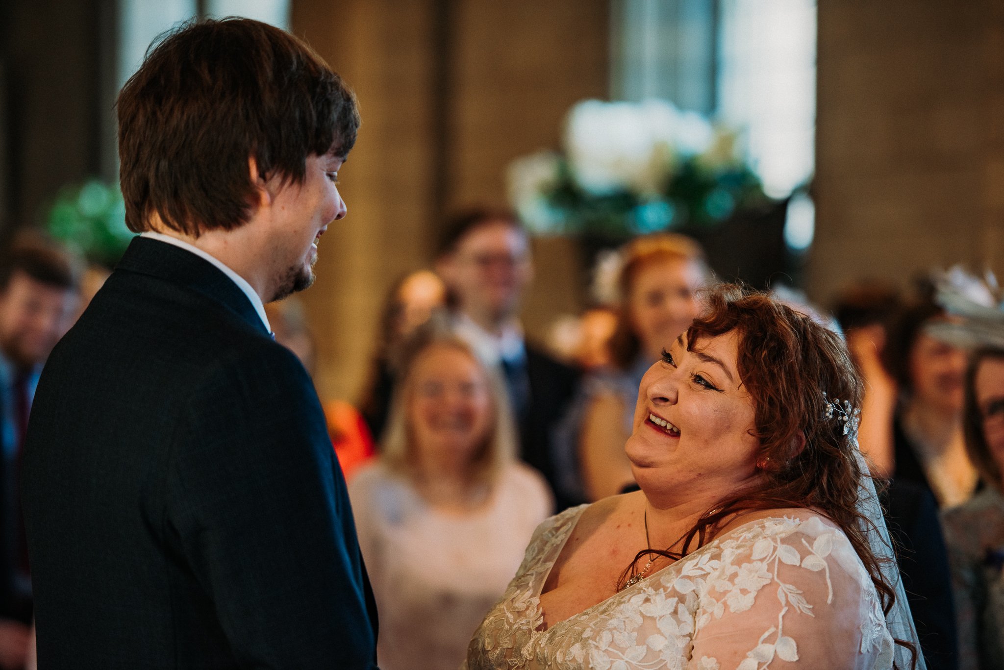 Bride and groom laughing during the wedding ceremony at Sneaton Castle, Whitby.