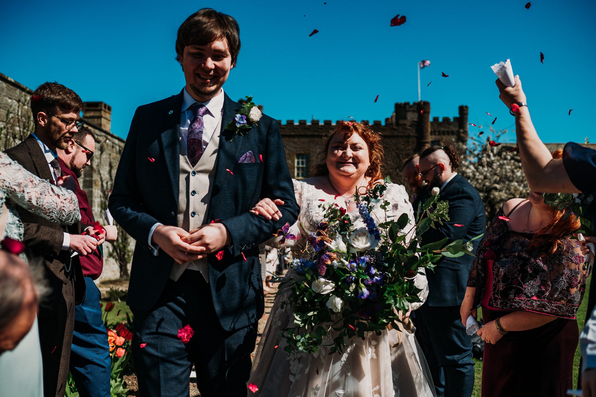 The bride and groom during the confetti line in the gardens at Sneaton Castle, Whitby.