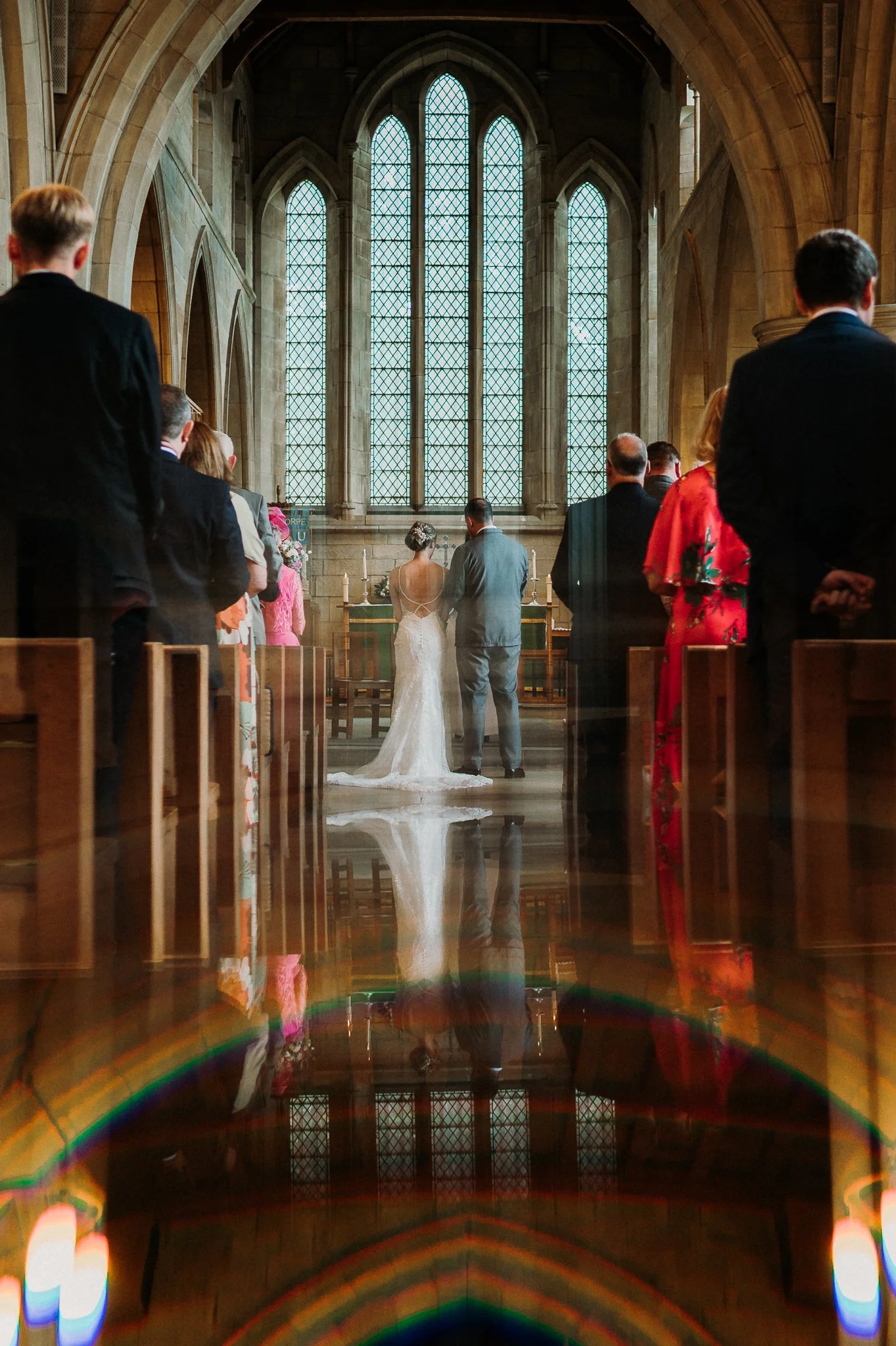 Bride and groom standing at the top of the aisle together on their wedding day.