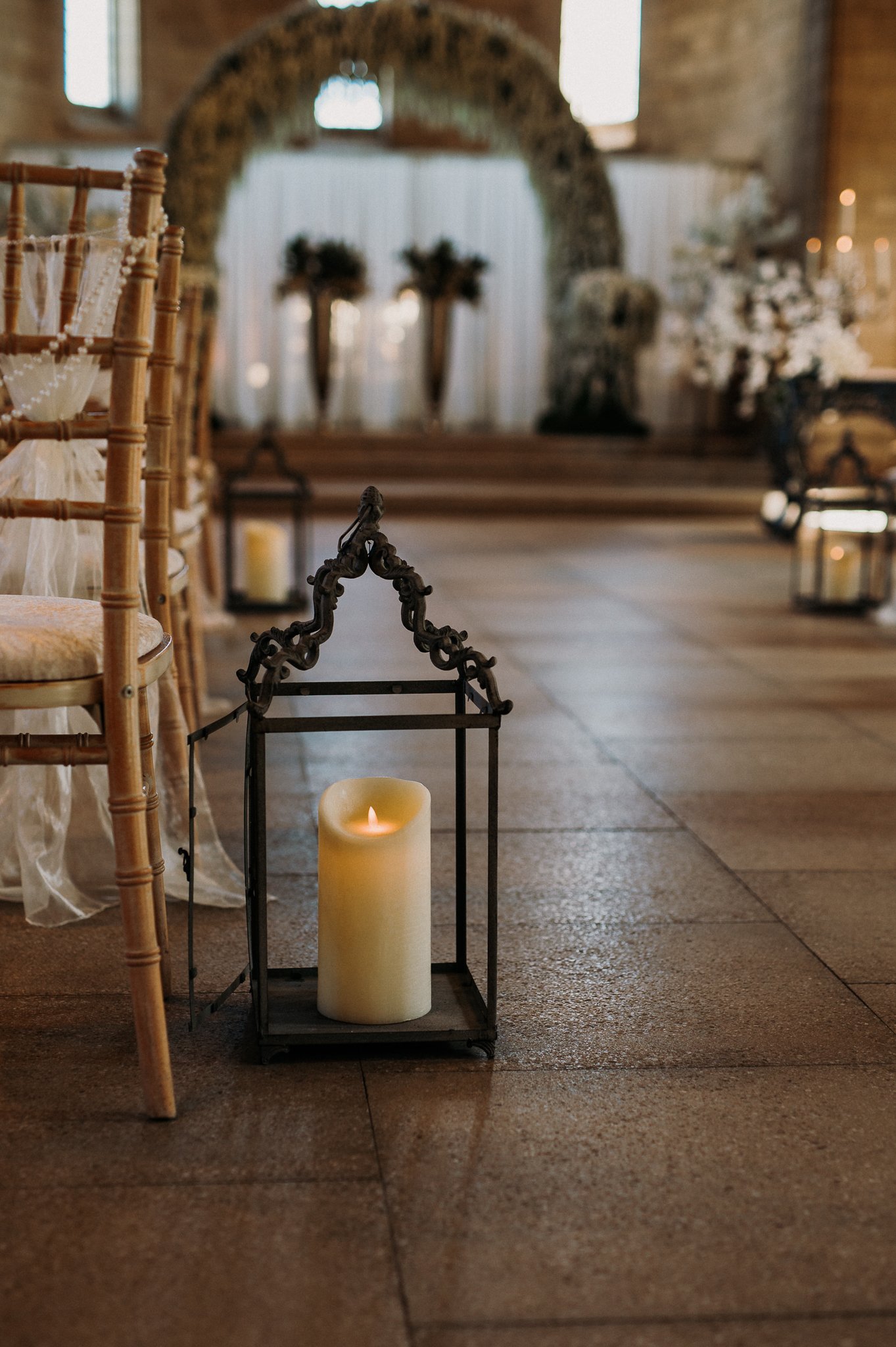 An artificial candle at the aisle end of the rows of seats waiting for the guests to enter for the wedding at Sneaton Castle, Whitby.