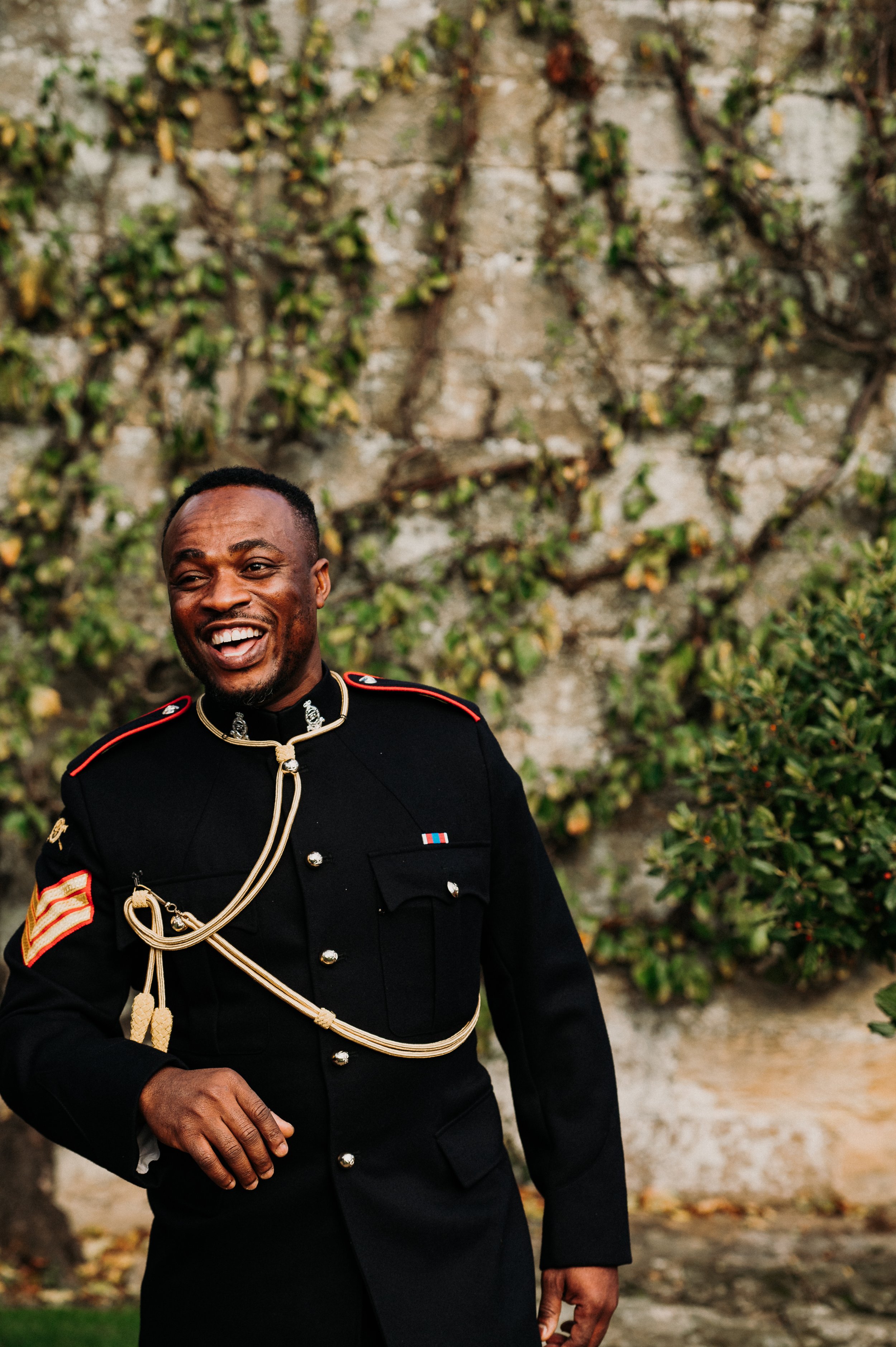 A member of the groom's sword guard in full uniform shares a laugh on the morning of the wedding at Sneaton Castle, Whitby.