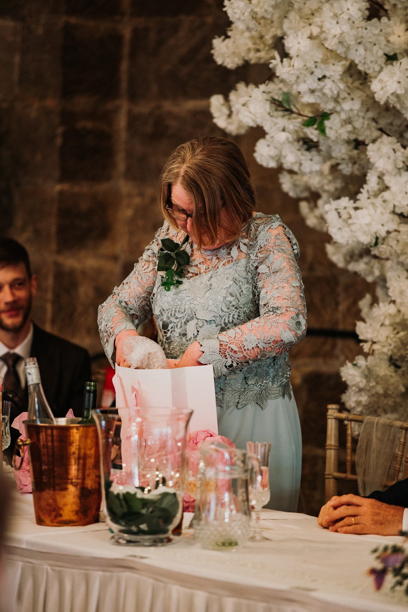 The mother of the bride unpacking a gift from the newly married couple at Sneaton Castle, Whitby.