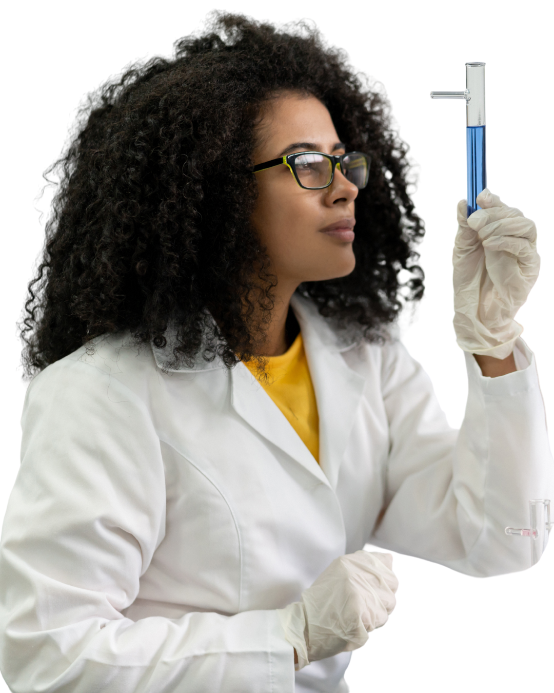 A female scientist in glasses and a white lab coat holding a test tube with blue liquid, examining it closely.