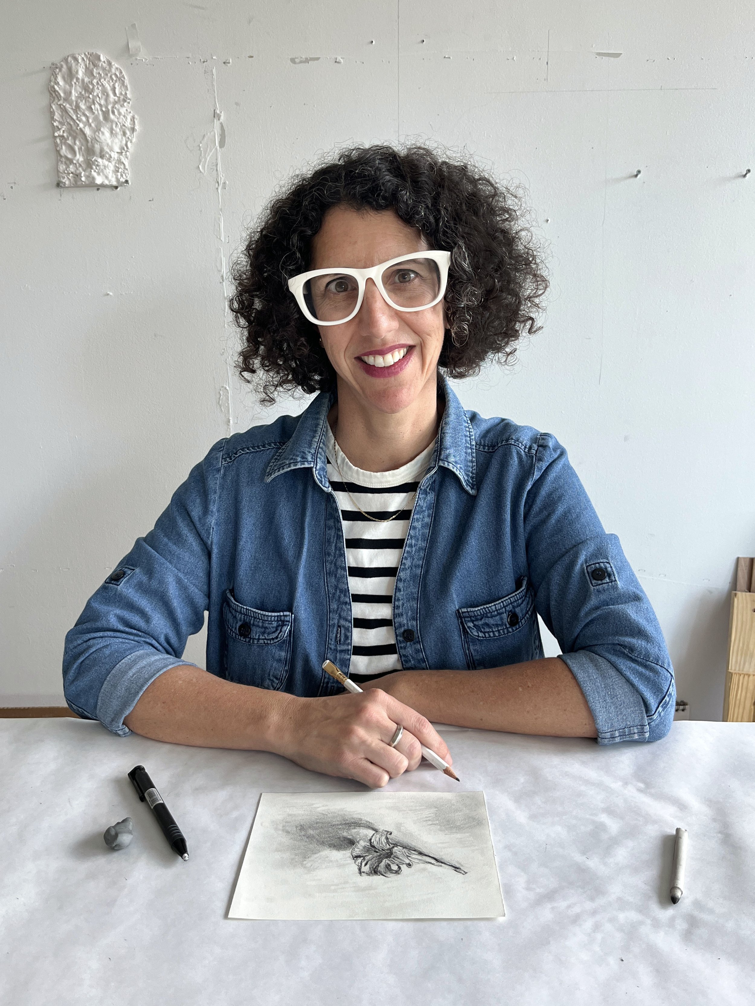 artist drawing at her work table
