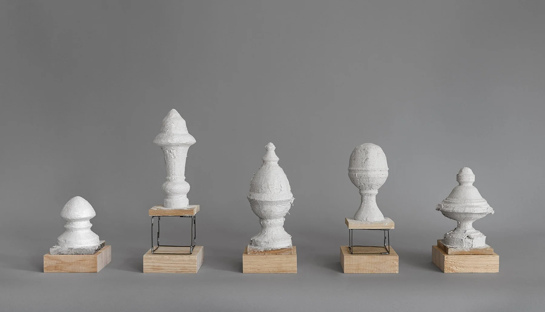 Finials: Study for Private Property. Lime plaster hand-mixed with aggregate from local demolition, scavenged wood, coathangers, wire, hardware. 2026