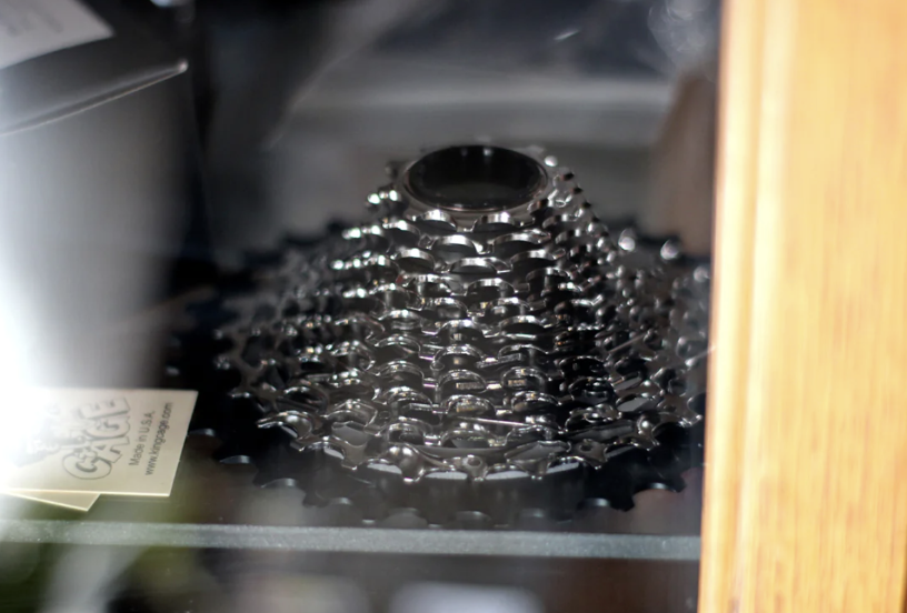 Close-up of a metallic coffee grinder with coffee beans inside