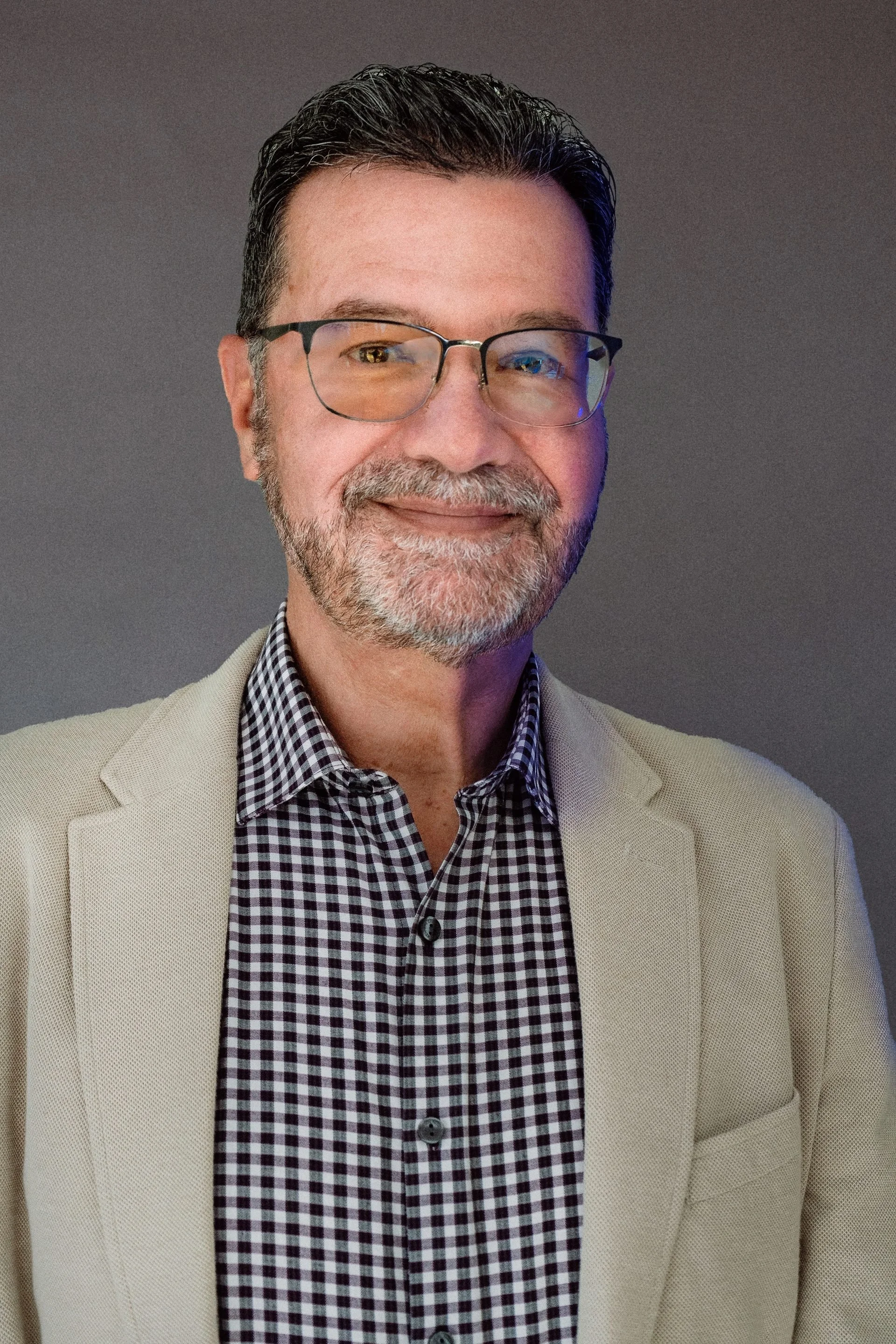 Chuck Binkerd, Executive Director of the Grant County Economic Growth Council, wearing glasses and a tan blazer in a professional headshot.