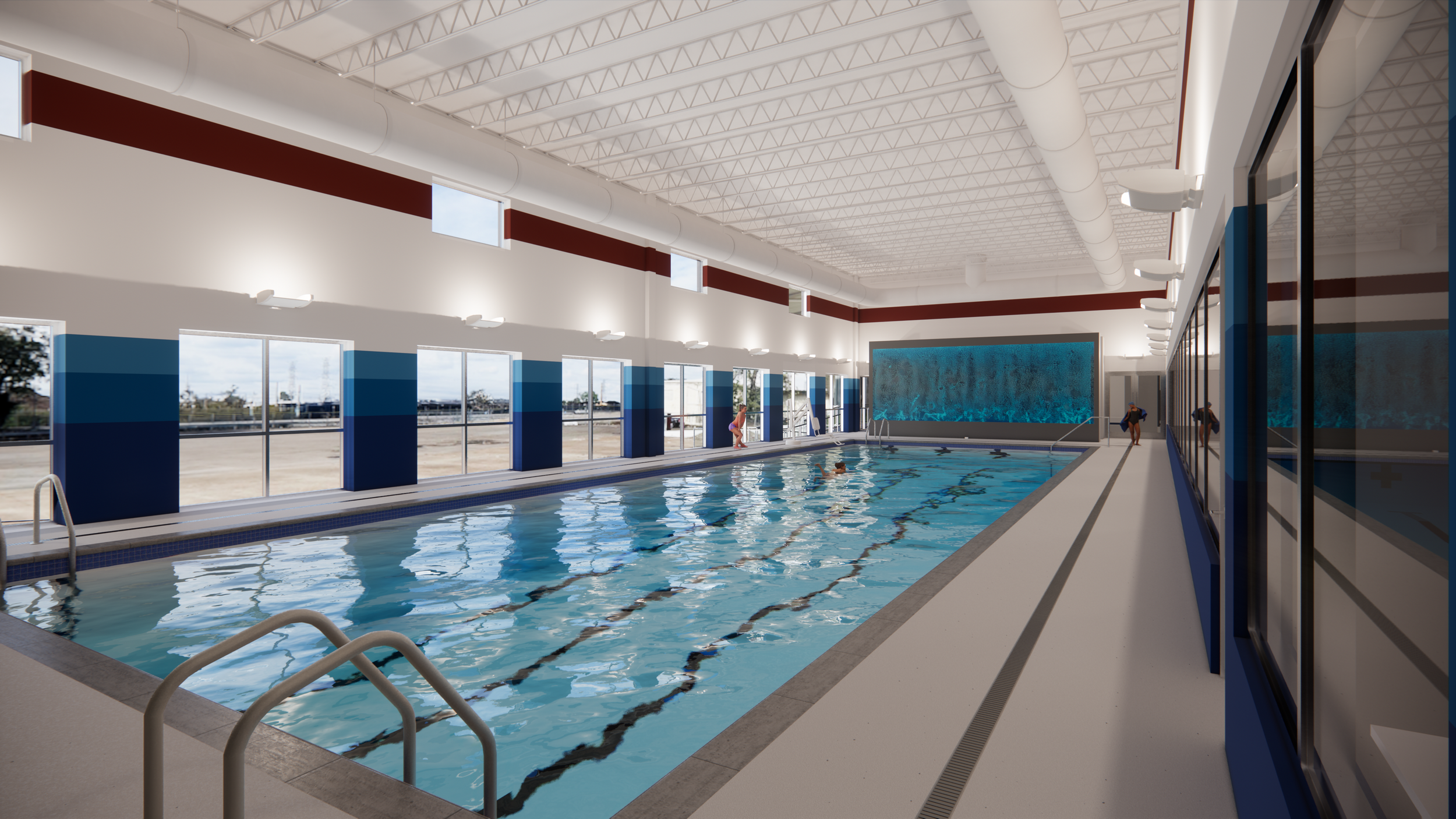Indoor swimming pool with large glass windows, blue and white walls, and a high ceiling with white beams. There are swimmers in the pool, and people are standing near the edge and in the water.