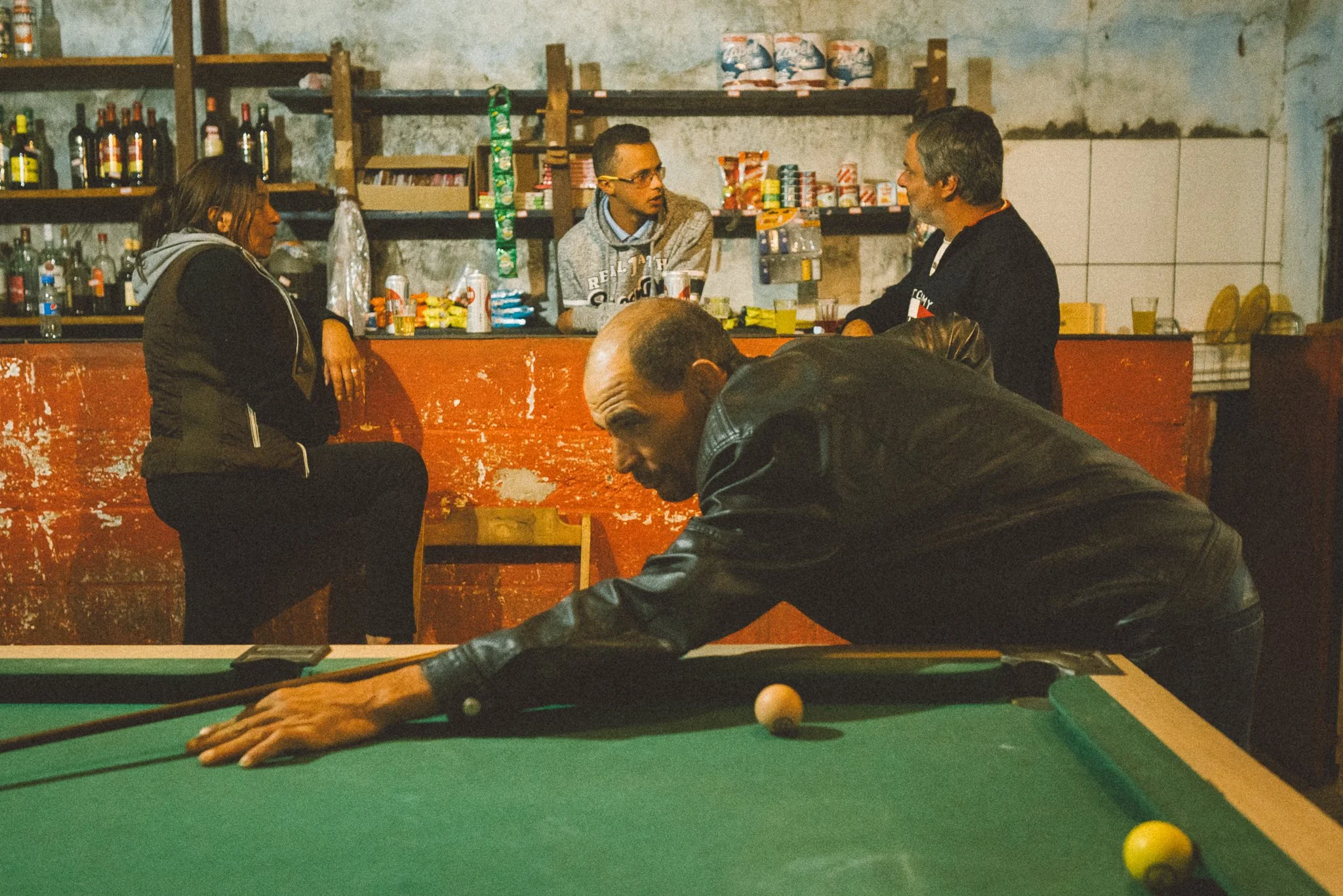 Zezé playing pool at a bar in Galheiros, Diamantina