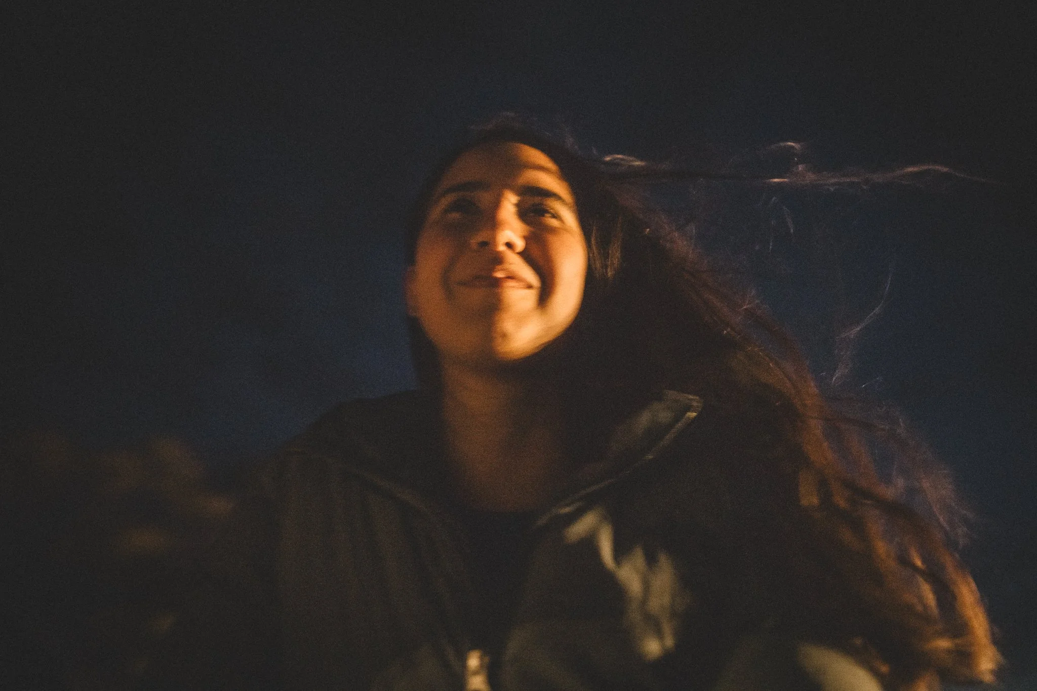 Elisa riding in the back of a pickup truck in Galheiros, Diamantina