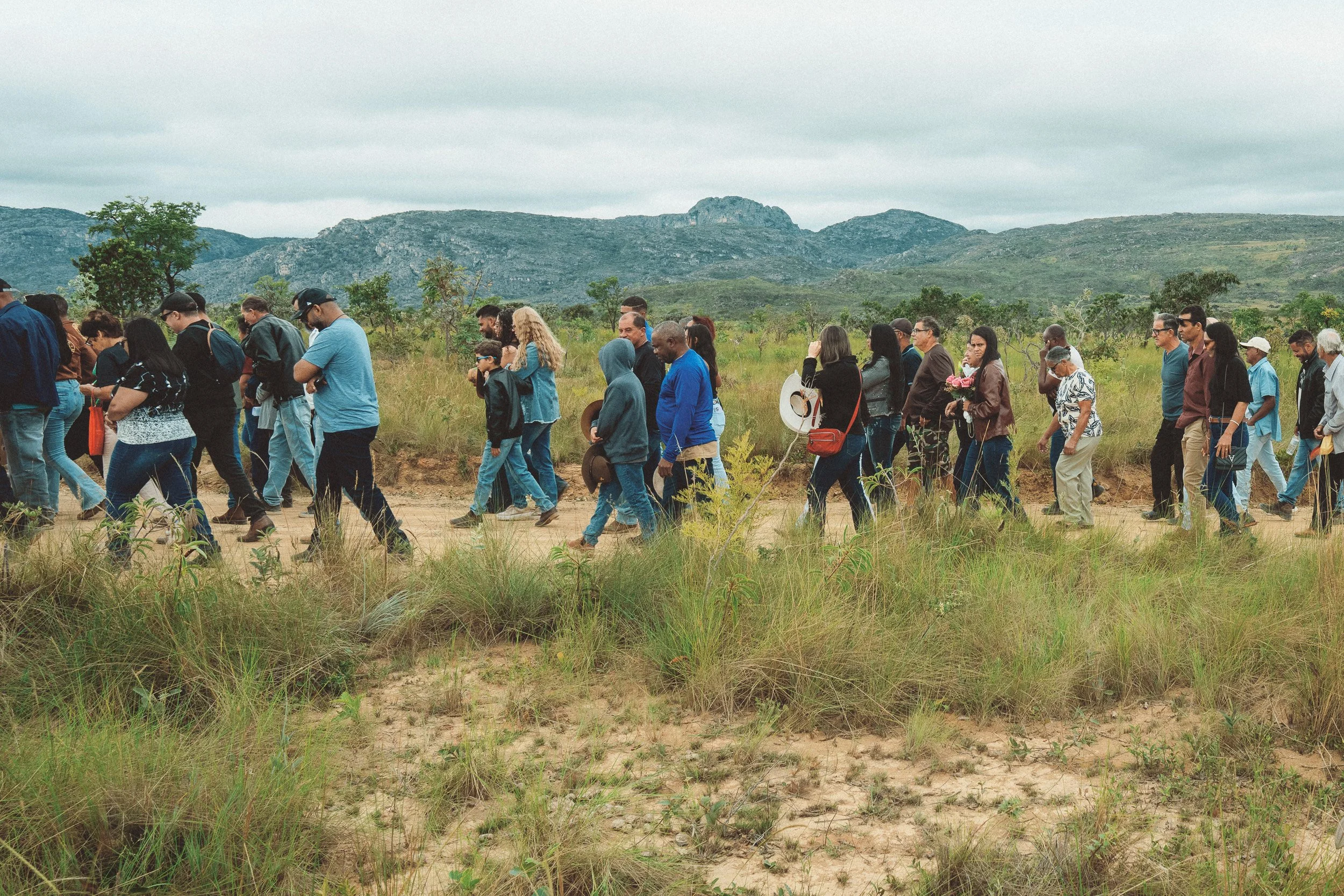 Locals walking along a dirt road during the annual procession in Santa Rita, Serra do Espinhaço