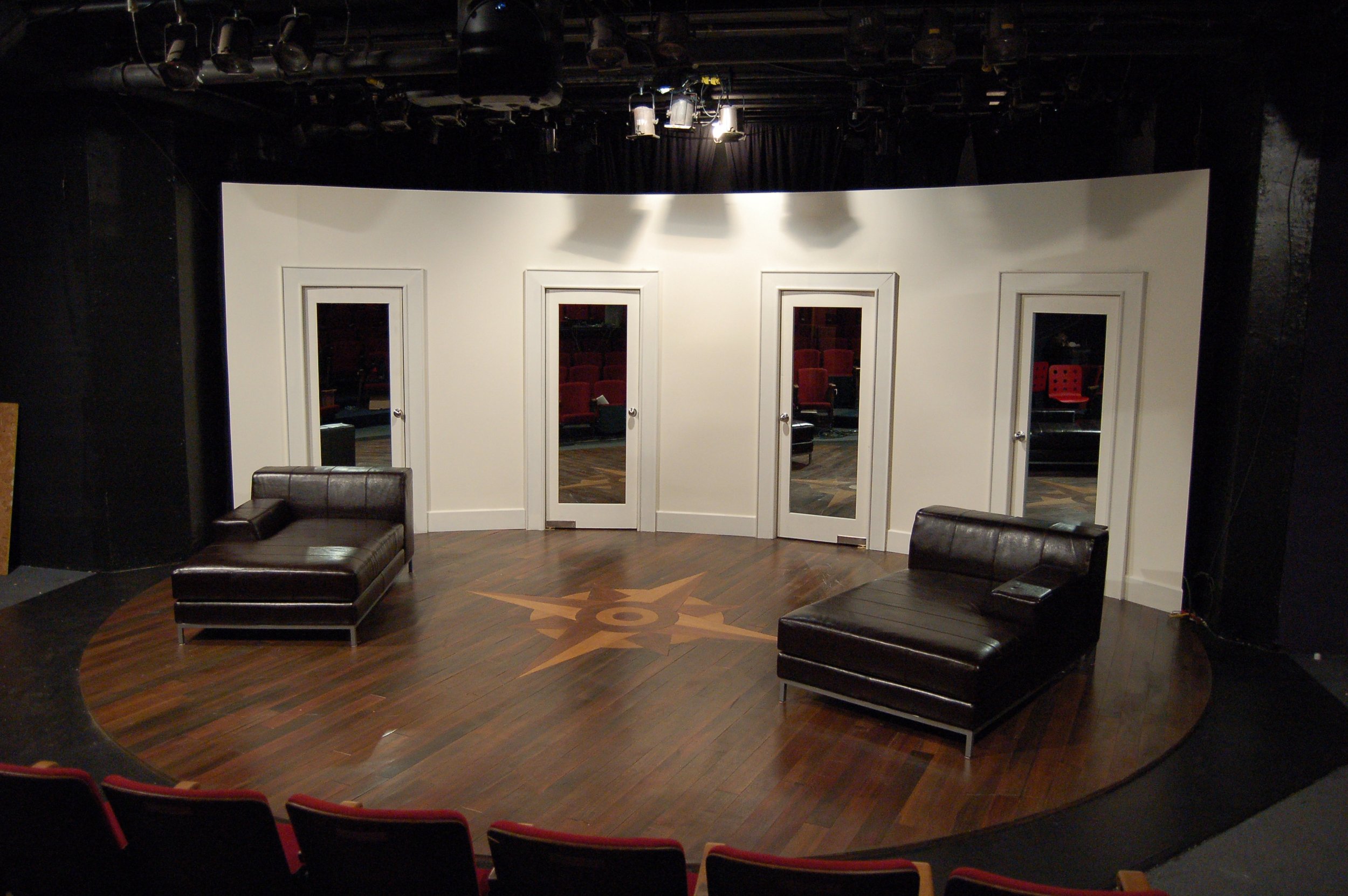 Custom built double-swing doors with 2-way glass mirrors. Curved walls. Custom compass inlay in stained lauan floor.  Tomorrow Morning  Hilary A. Williams, Producer, Chicago IL (2008) Carpenter, Crosstown Scenic