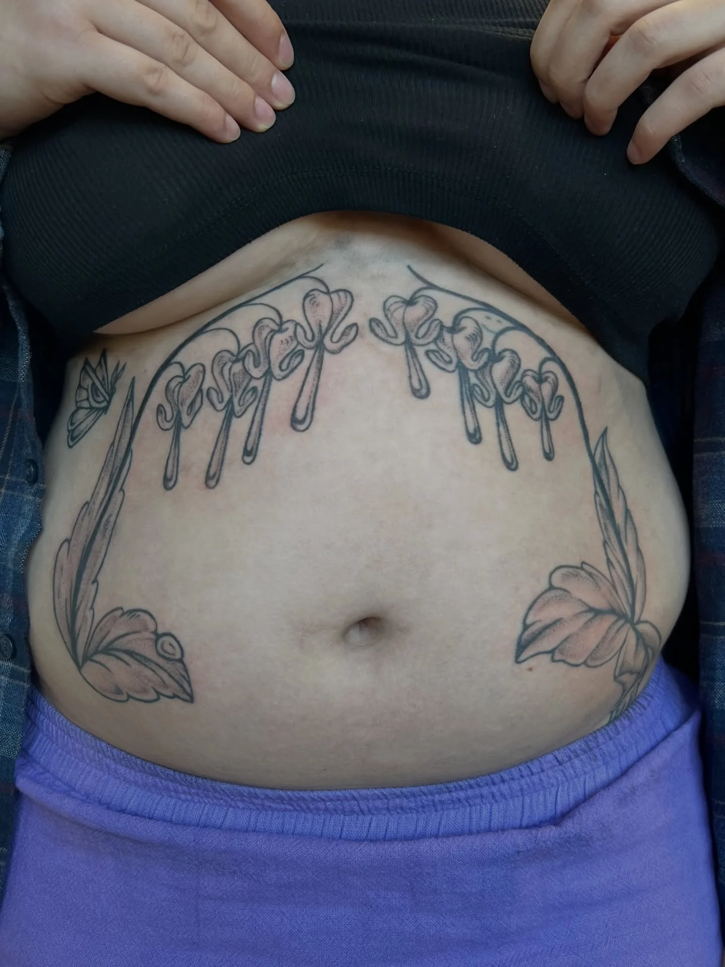 dewy bleeding hearts and radiant moth tattoo for cora 🦋👁️🌷💧 some healed some fresh, lil bit of a smiley face blast over on the left side too. :) thanks so much for the trust on this beautiful project!