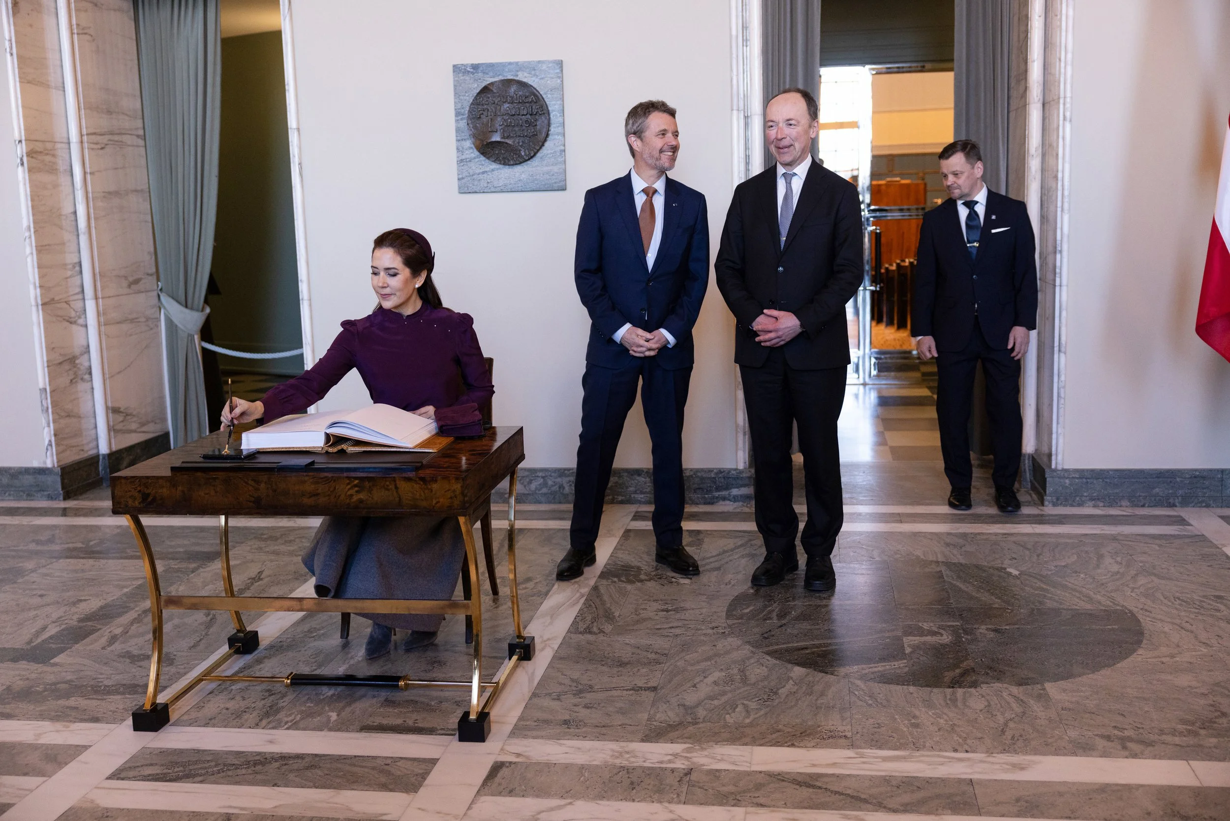 King of Denmark, Frederik X jokes with the Speaker of the Parliament of Finland, Jussi Halla-Aho while queen Mary of Denmark signs the visitors' book of the Parliament House.

4.3.2025, Helsingin Sanomat.