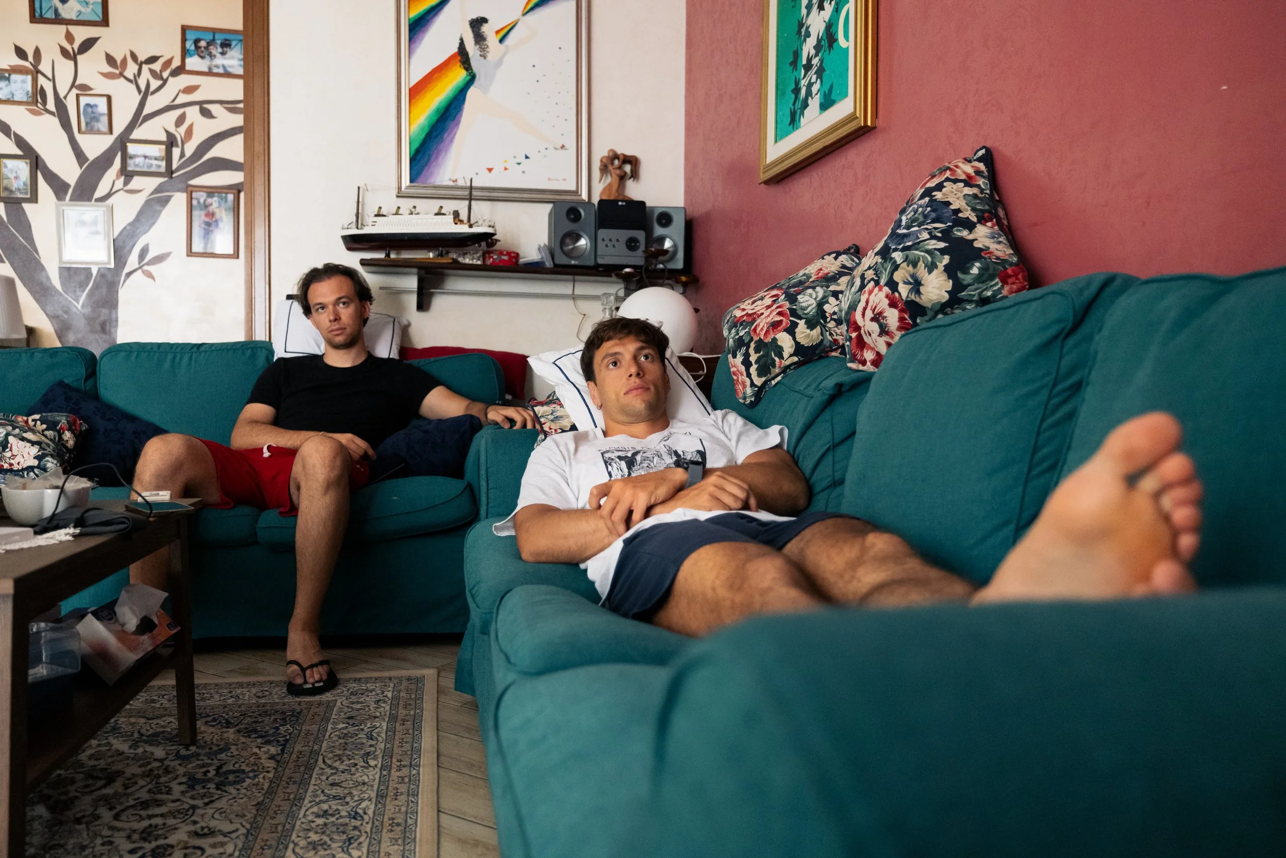 Mattia and Daniele Melezi watching television. A reportage about how young Italian people live with their parents due to the high living costs in Italy.