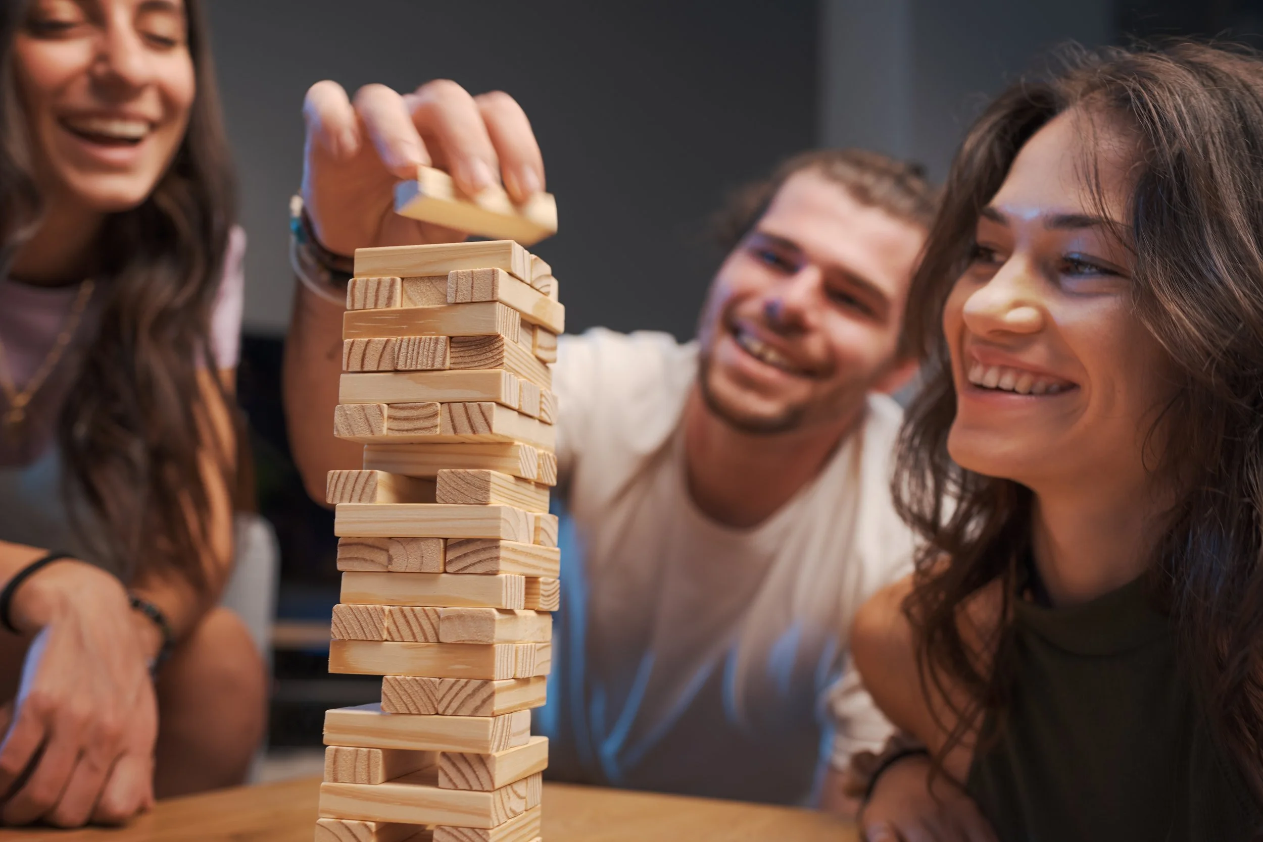 Adults happily playing jenga