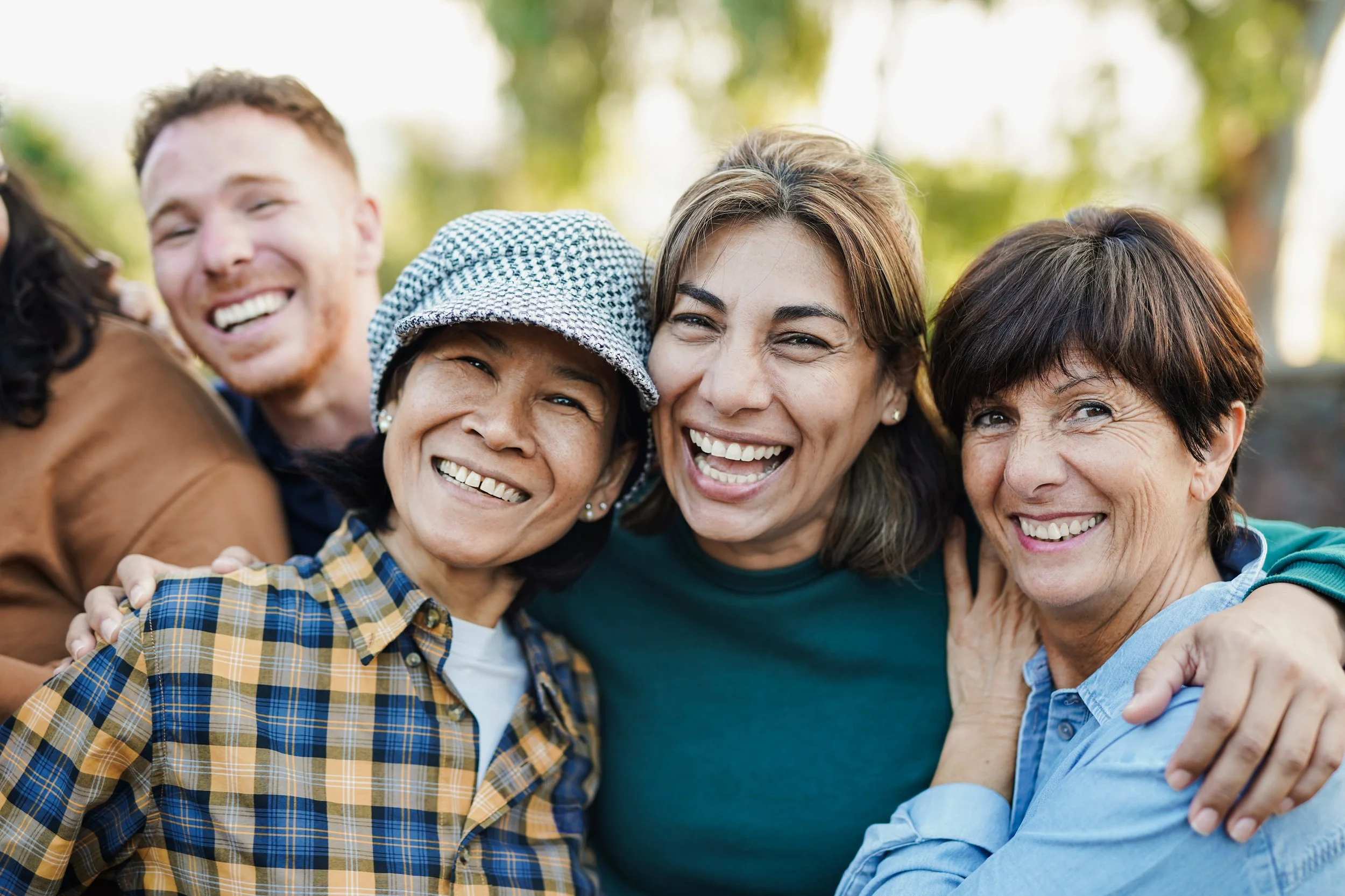 Three smiling adult women next to each other