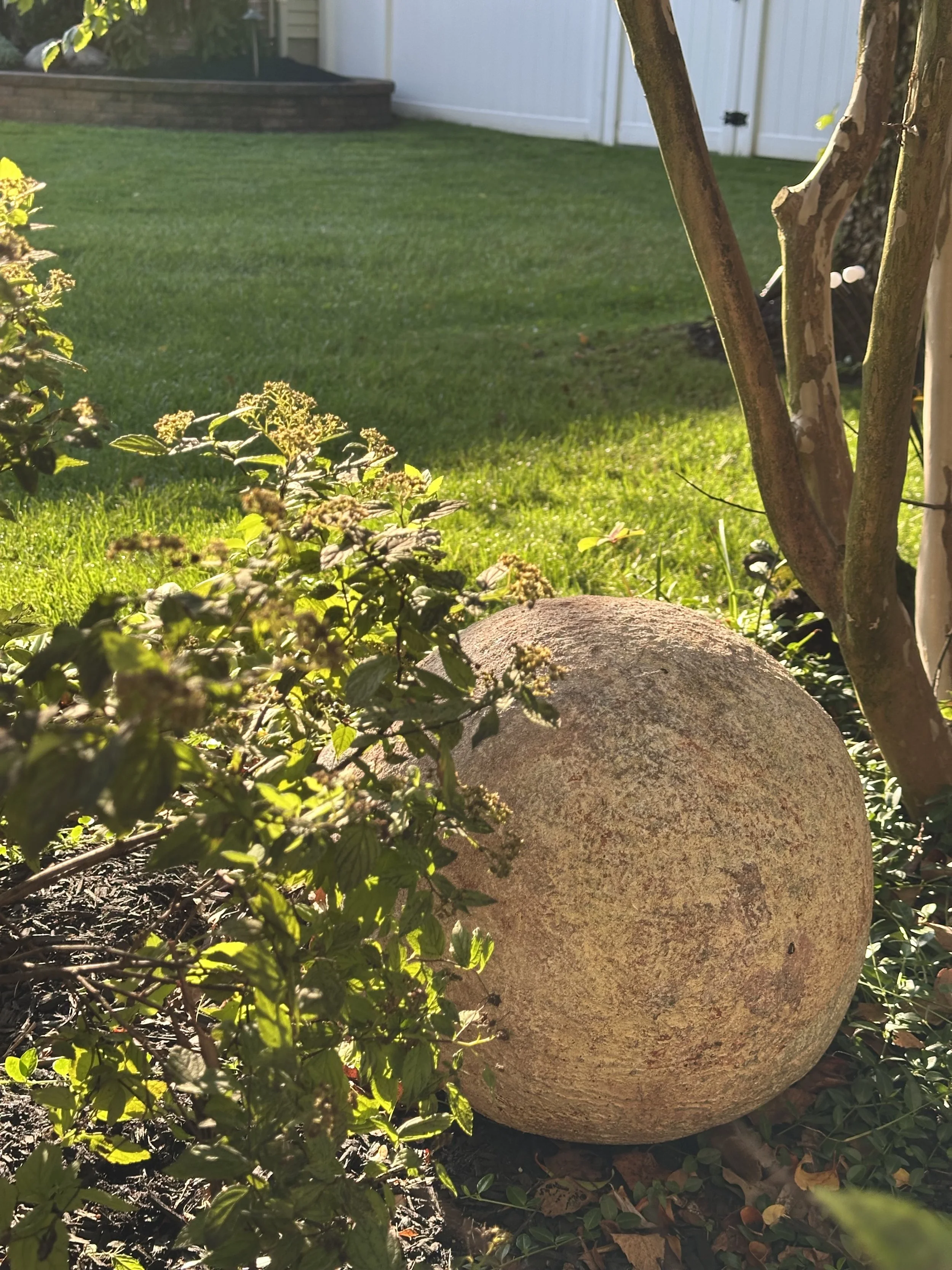 A sphere basking in the golden glow in a garden