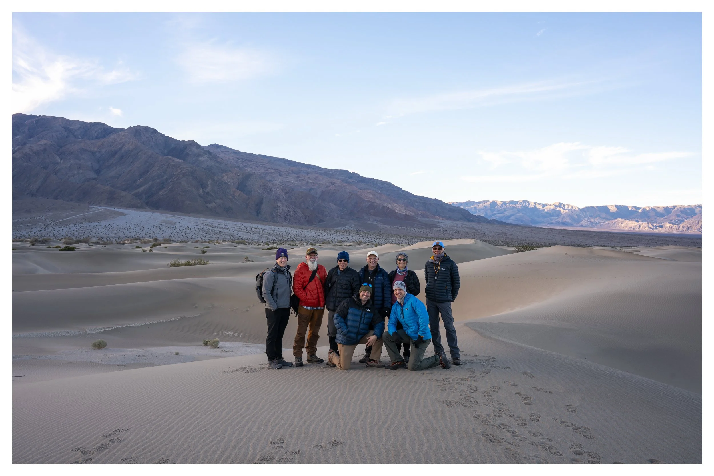 Photographers standing on sand dune in the mesquite dunes area of death valley national park, during photography workshop taught by Andrew Hertel