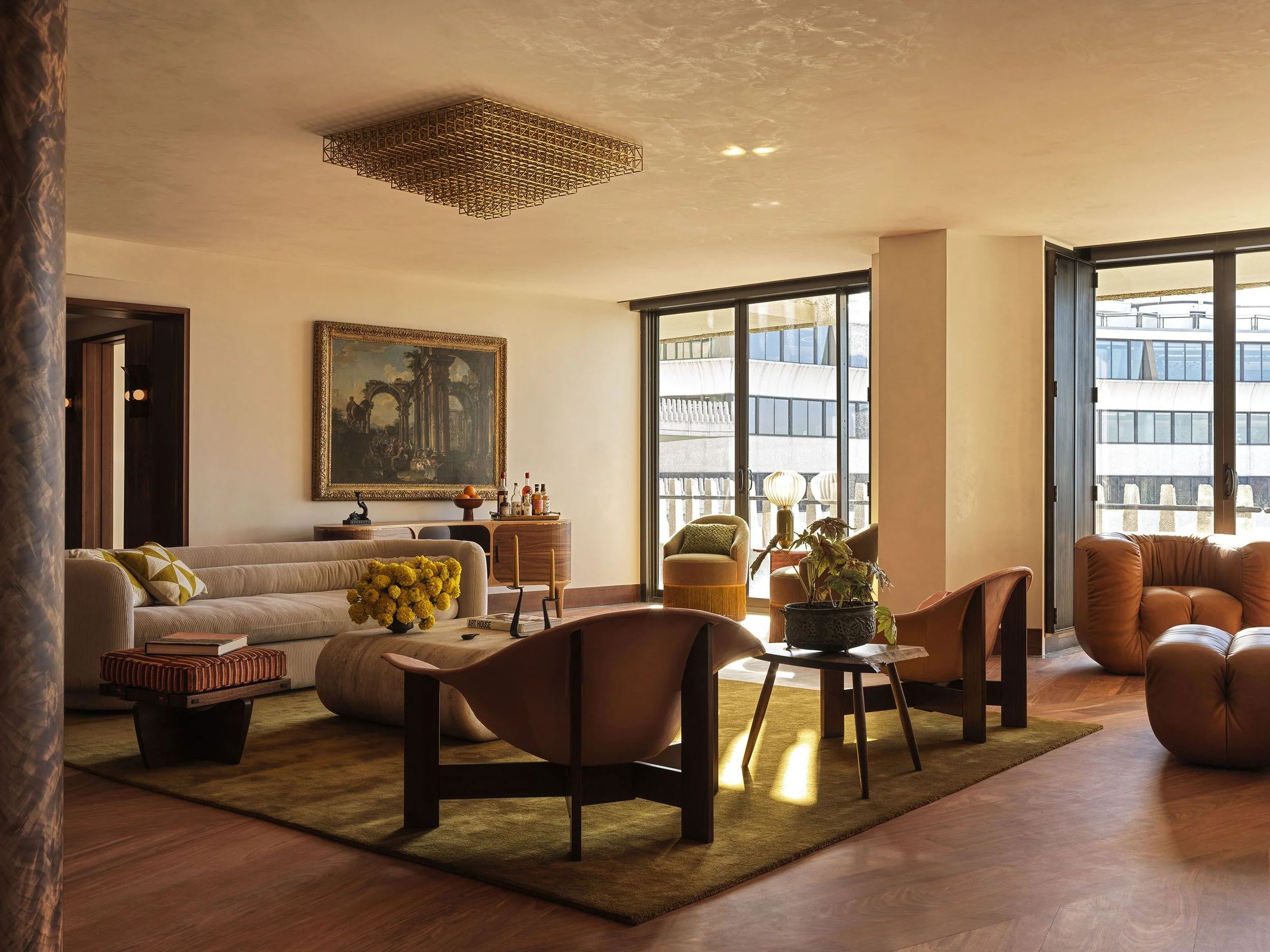 A living room featuring sculptural modern furniture, and an monumental 18th century painting, looking toward the Potomac River