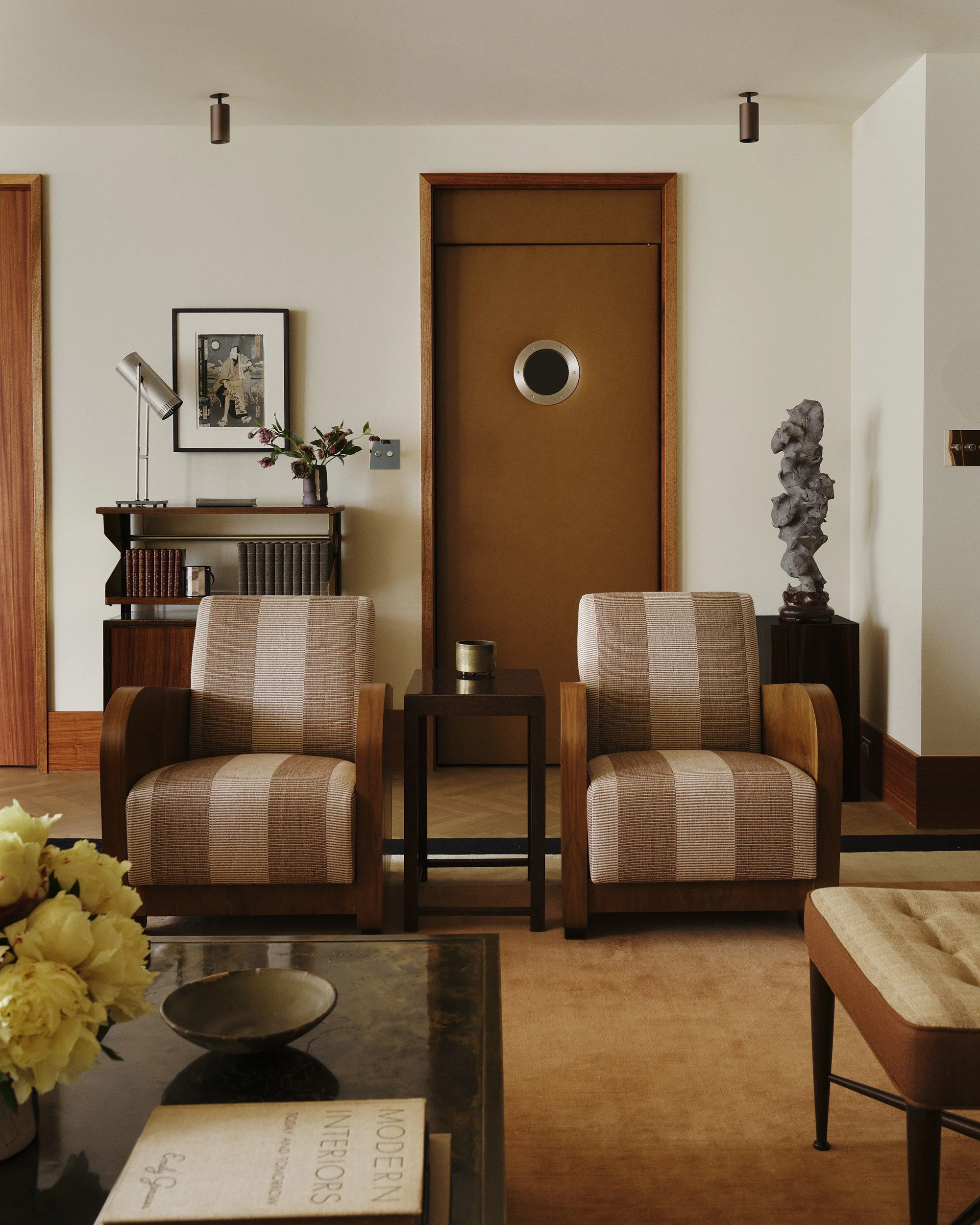 A detail of a living room with a leather clad door and a porthole