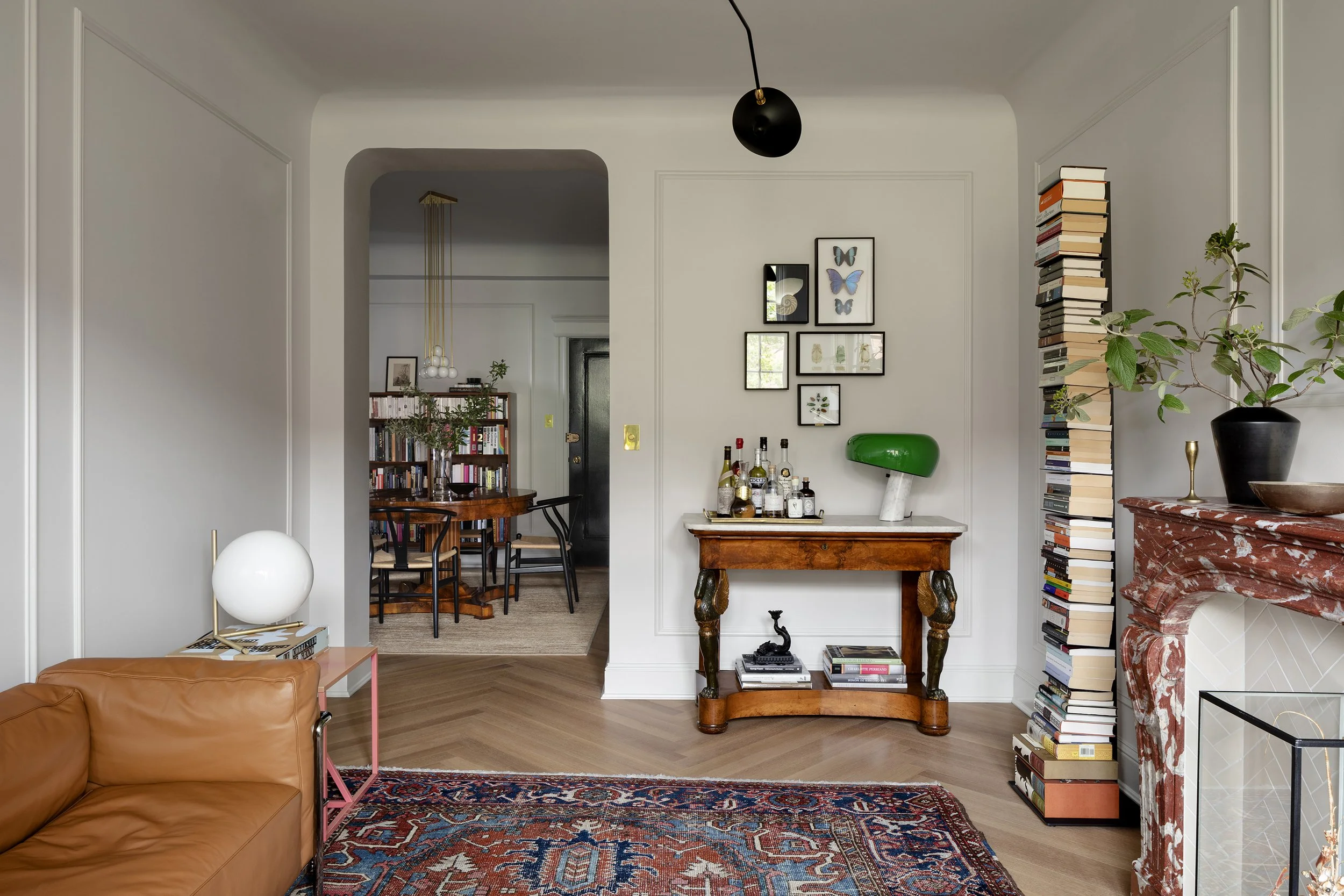 A living room in an apartment designed by architect Nicholas Potts with a filleted ceiling cove and an antique carpet