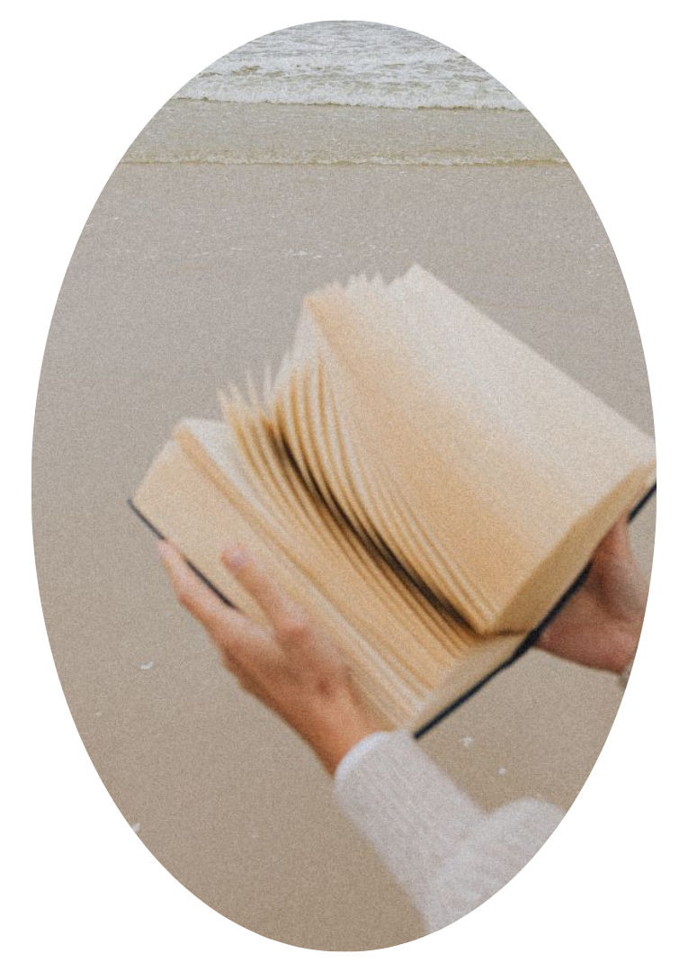 Hands holding an open book with blank pages, symbolizing a blueprint of the inner world.