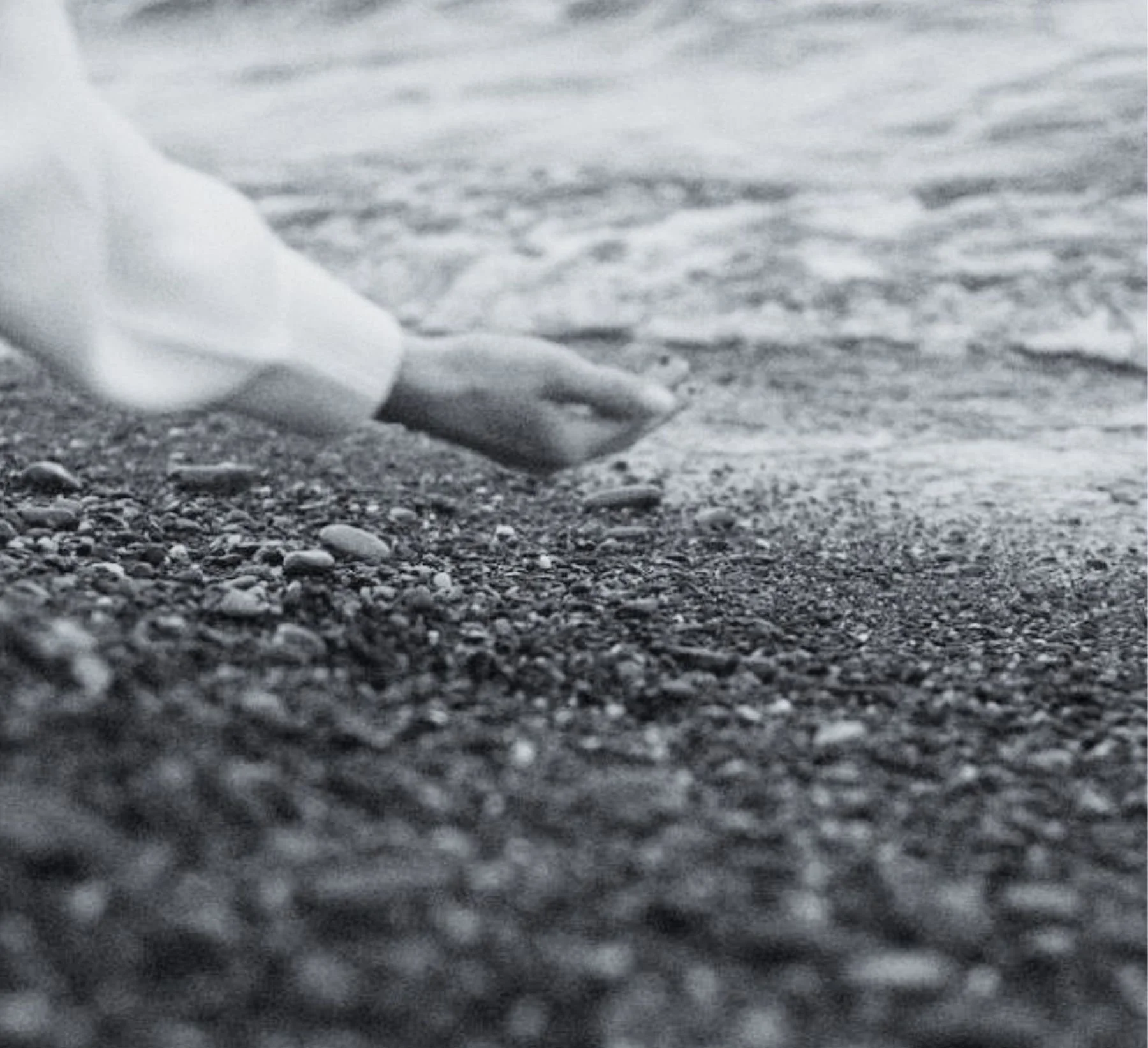 An open hand and shallow waters at the shore.