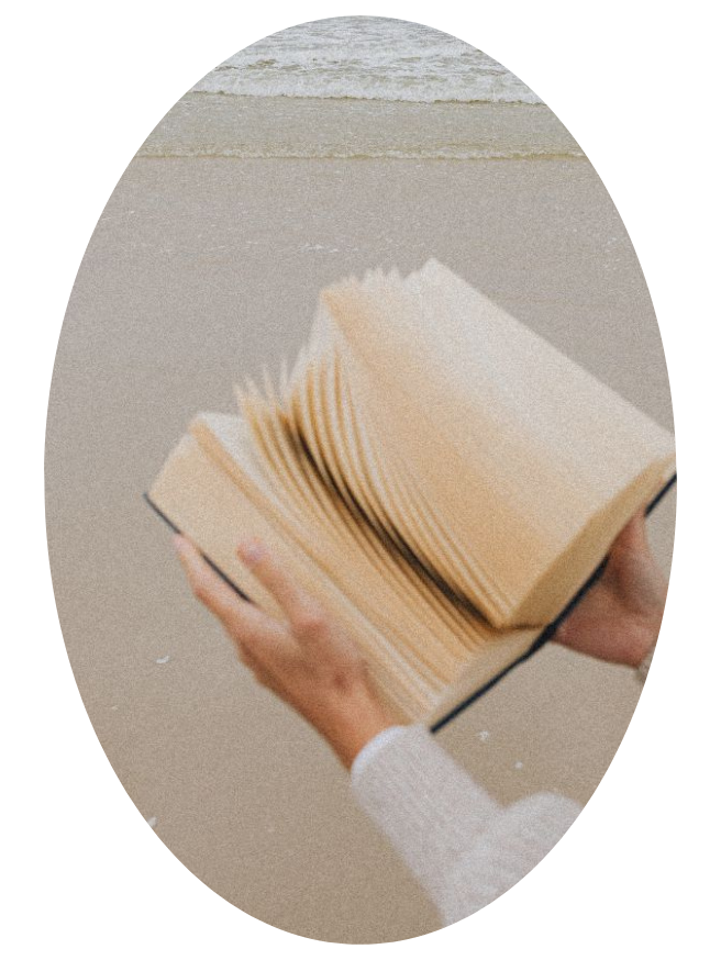 A close-up of hands holding an open book with blank pages, representing an unwritten life journey and self-discovery.