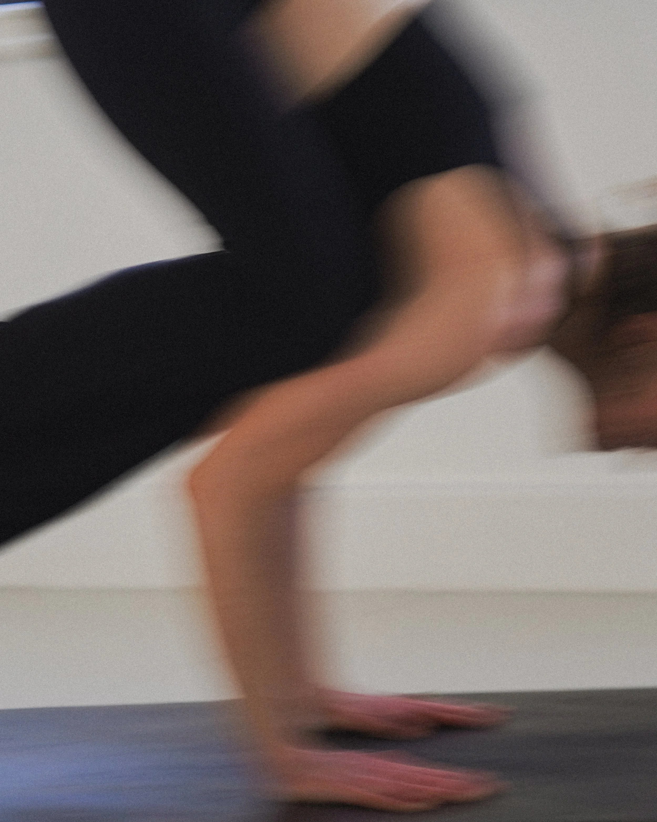 Woman moving through a yoga pose in yoga studio in London. 
