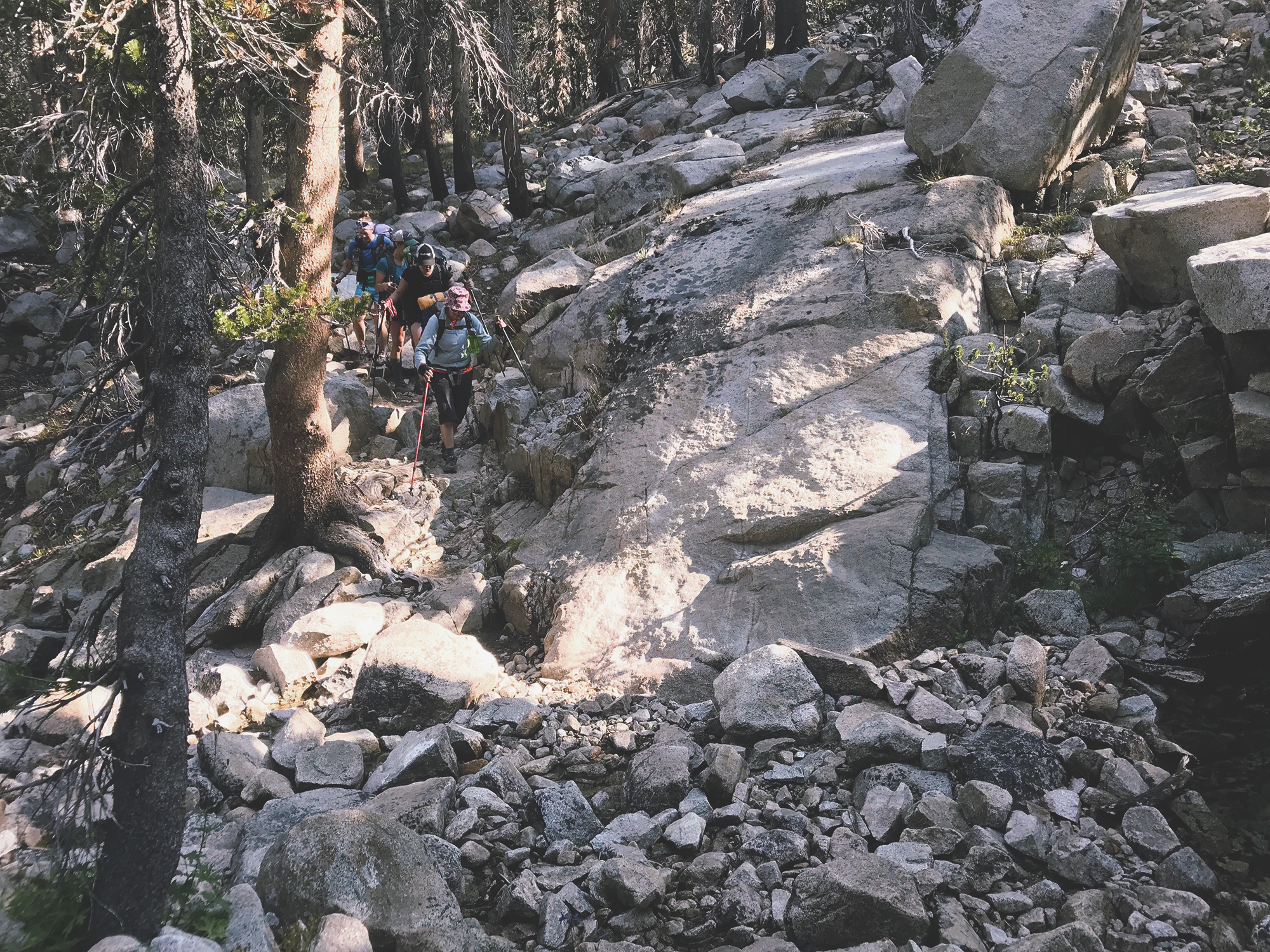 group_hiking_between_rocks_piute.png