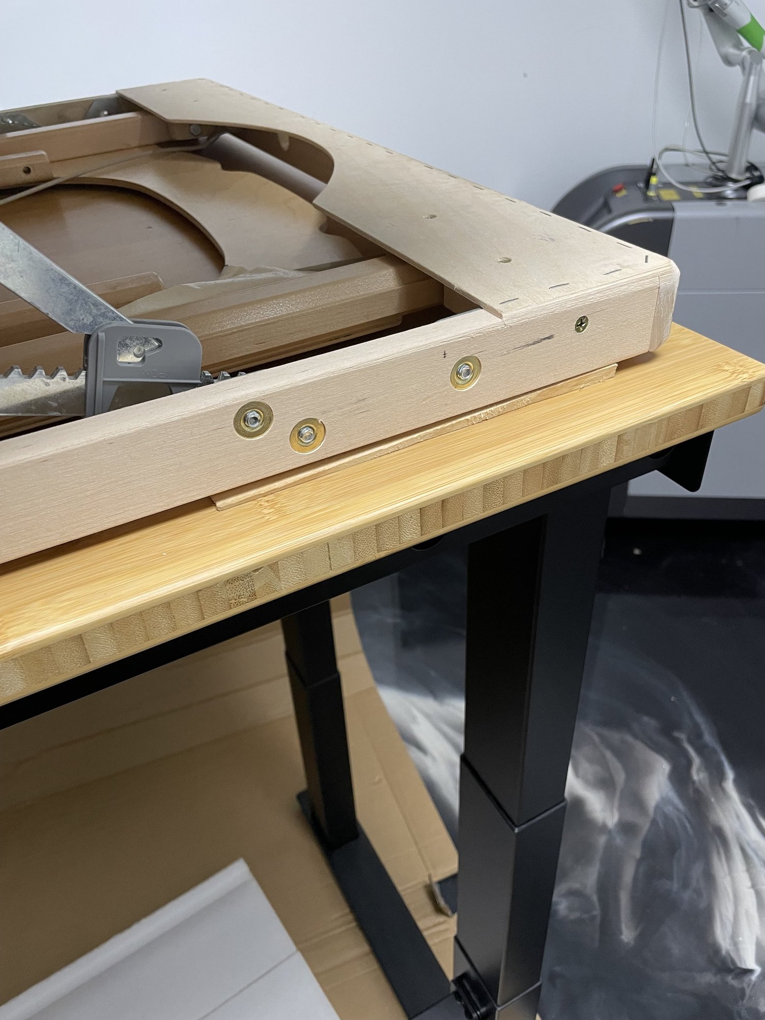 Drilling pilot hole through shim into bamboo desktop