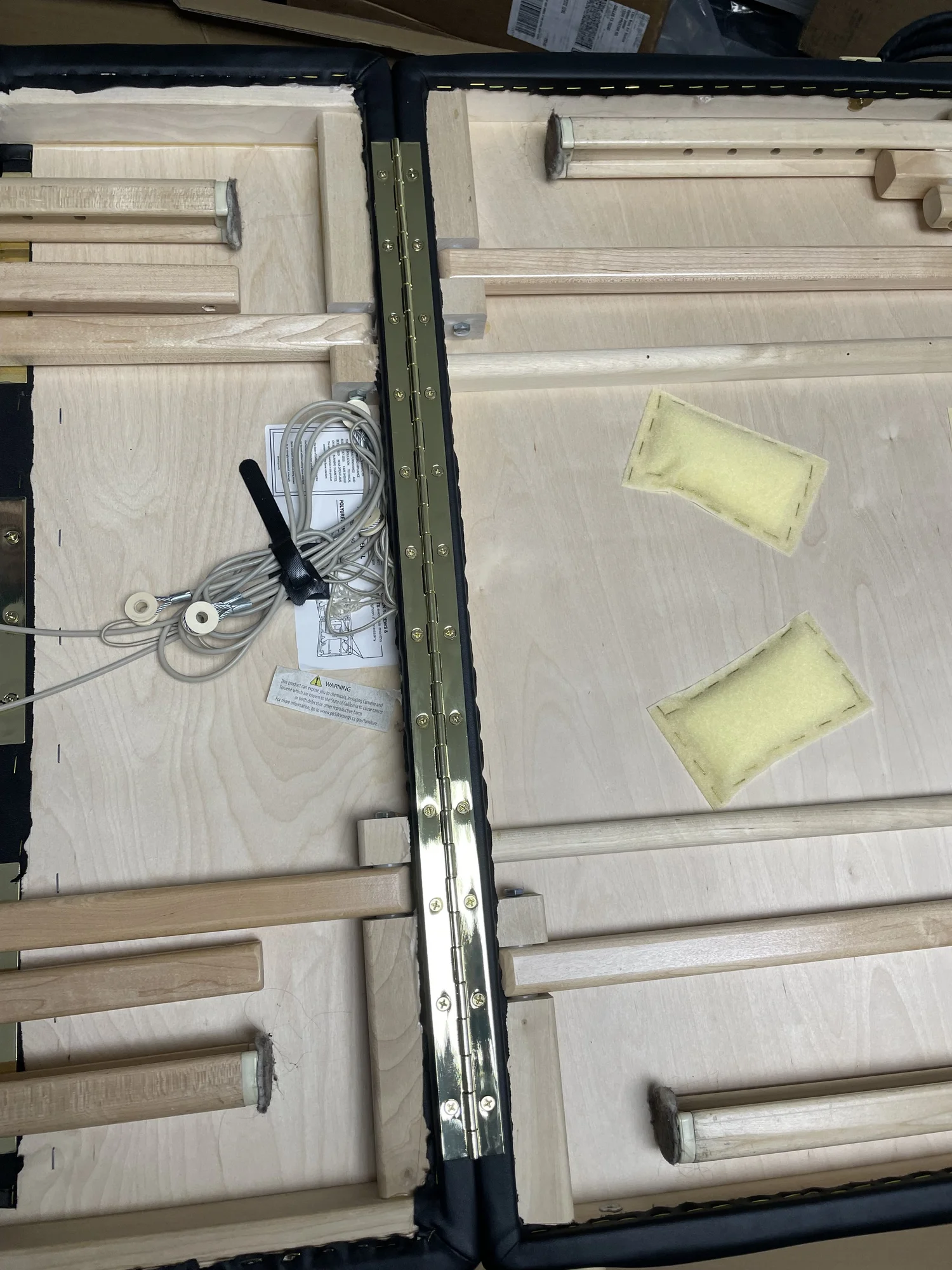 Removing screws from golden hinge on massage table