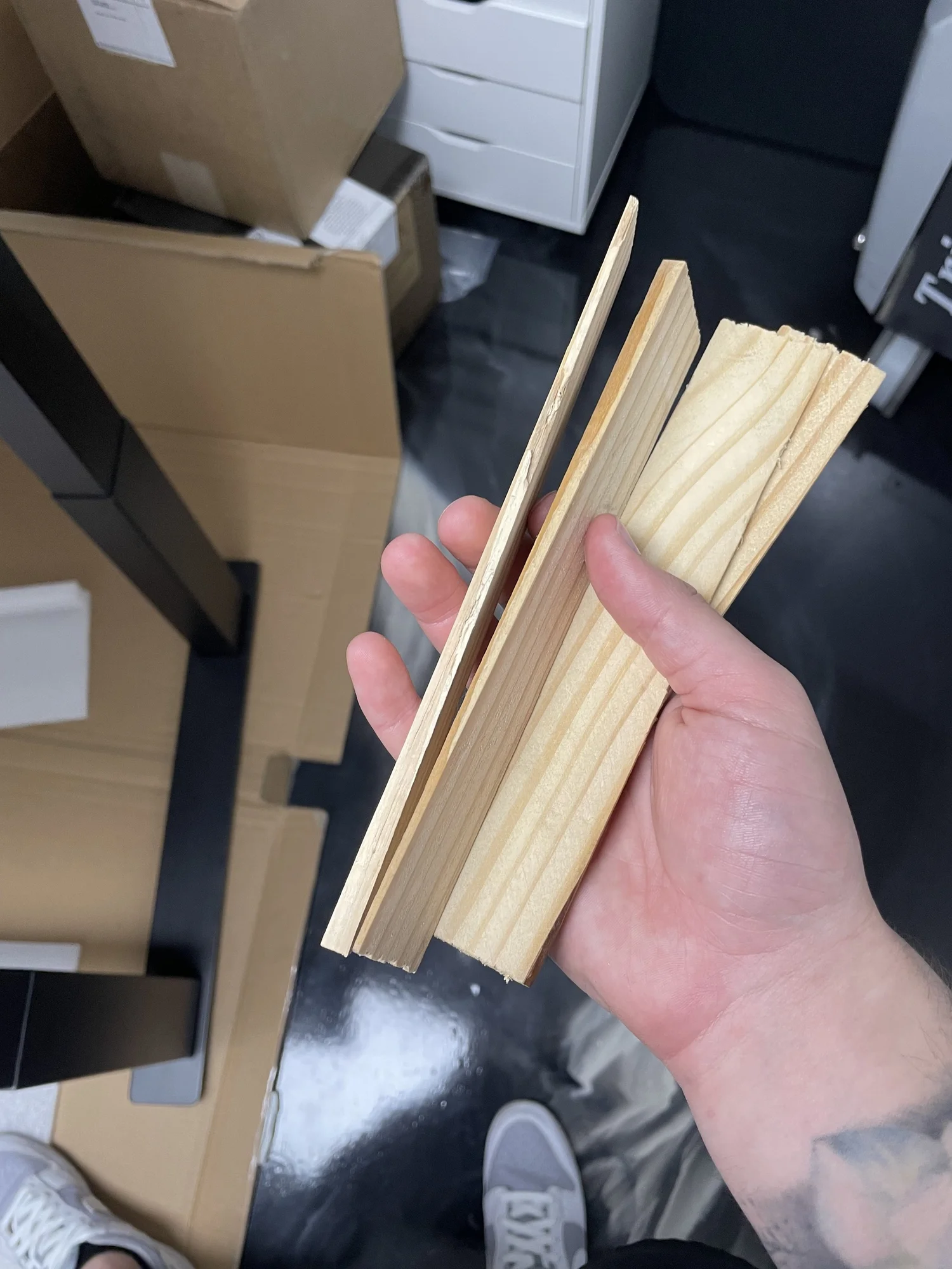 Shim positioned underneath massage table frame on bamboo tabletop