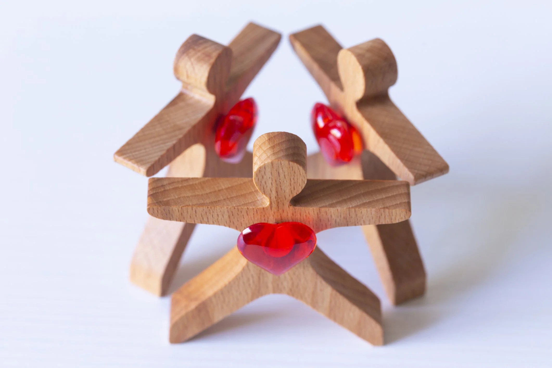 Wooden family standing in triangle