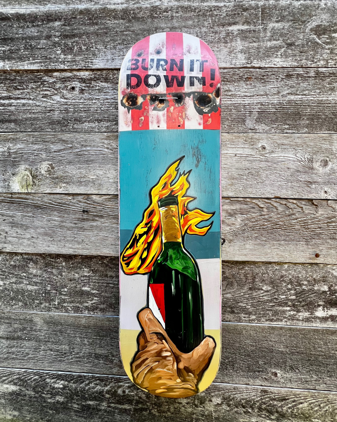 Burn It Down, mixed media on skateboard by Hoey Xōchitl, Zandra X and Timothy Wilson Hoey, 8.5x32.5 inches, 2026
