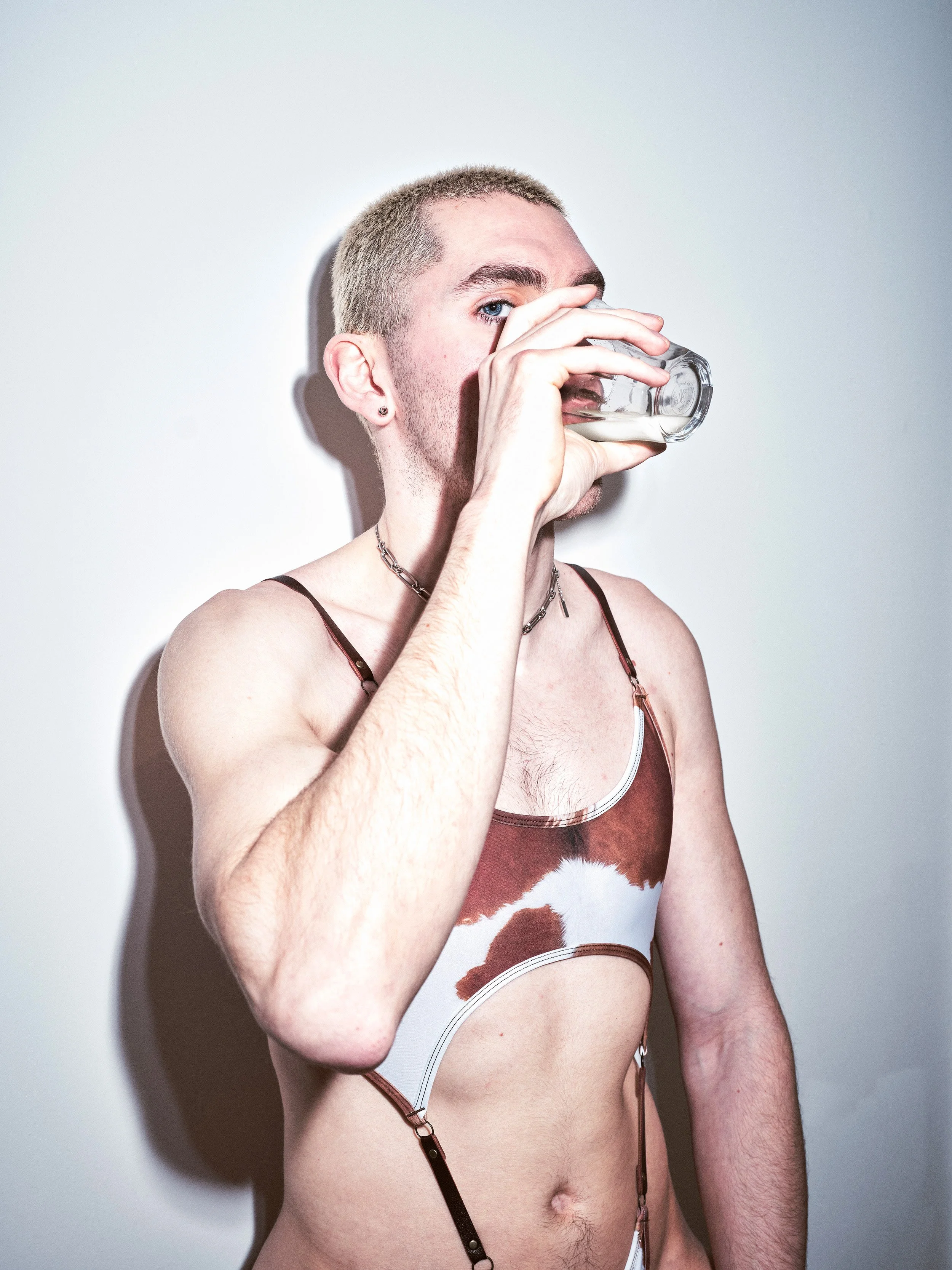 Portrait photograph by London based photographer Maxwell Anderson of artist model Todd Lamming shot for a fashion editorial portraying a queer erotic and domestic banal interaction using flash photography.