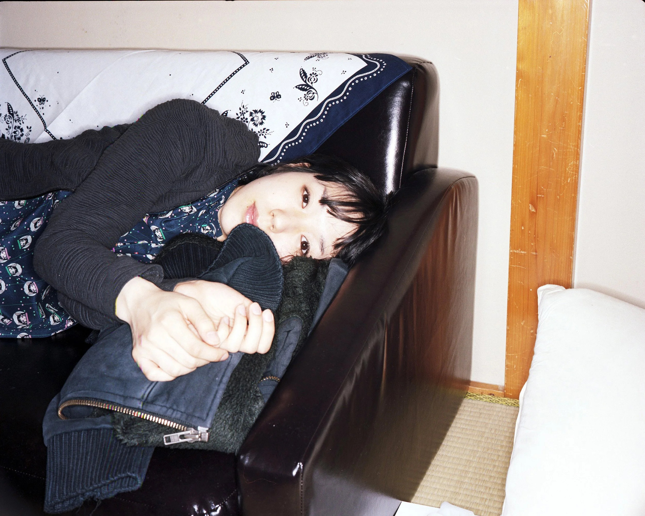 Portrait photograph of a woman on a sofa by photographer Maxwell Anderson