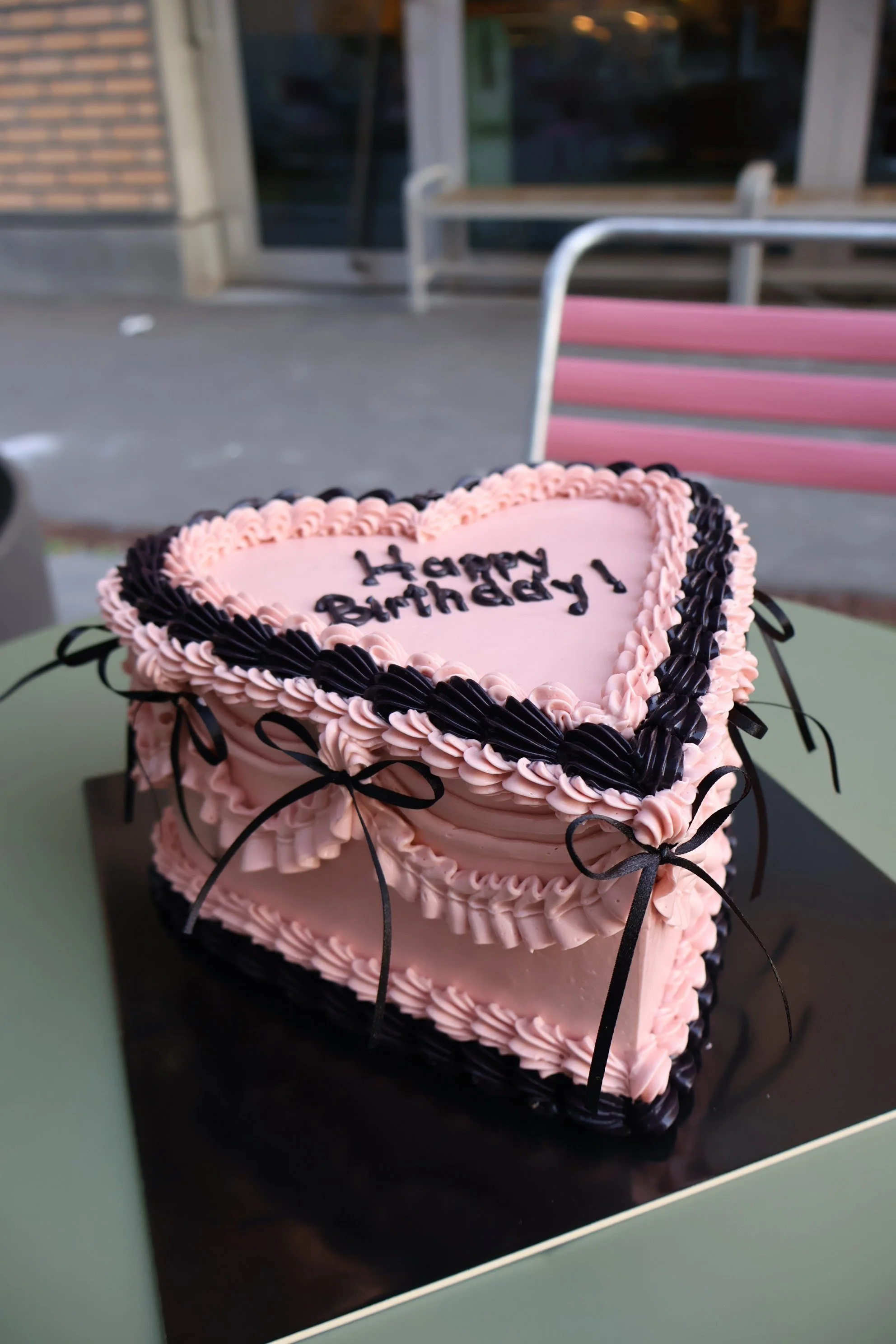 Heart shaped birthday cake with vintage piping and bows
