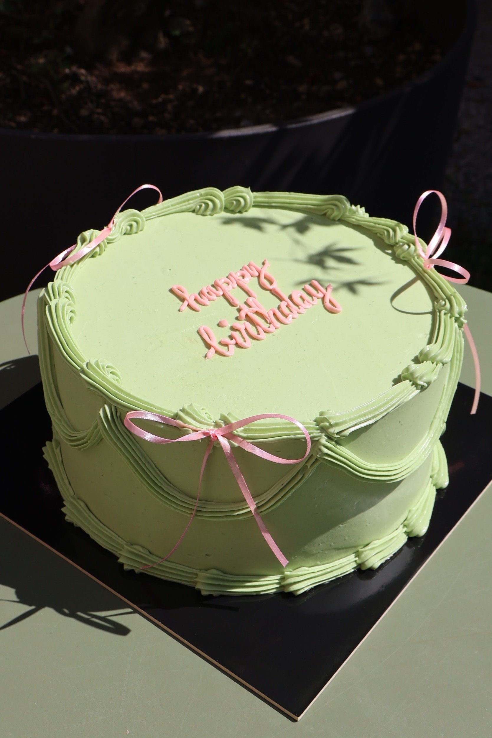 Birthday cake with bows and vintage piping