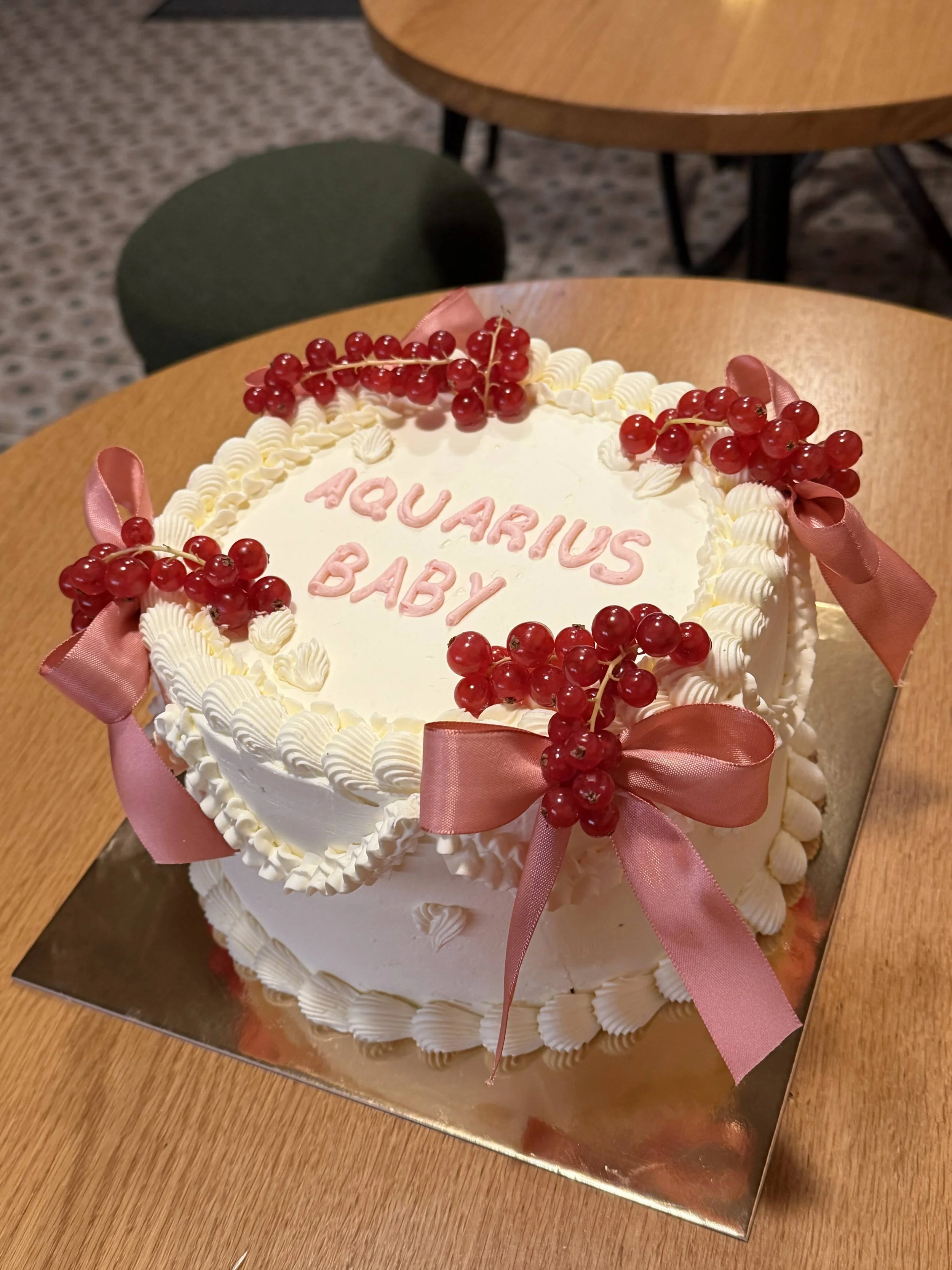Heart shaped gender reveal cake with vintage piping berries and bows