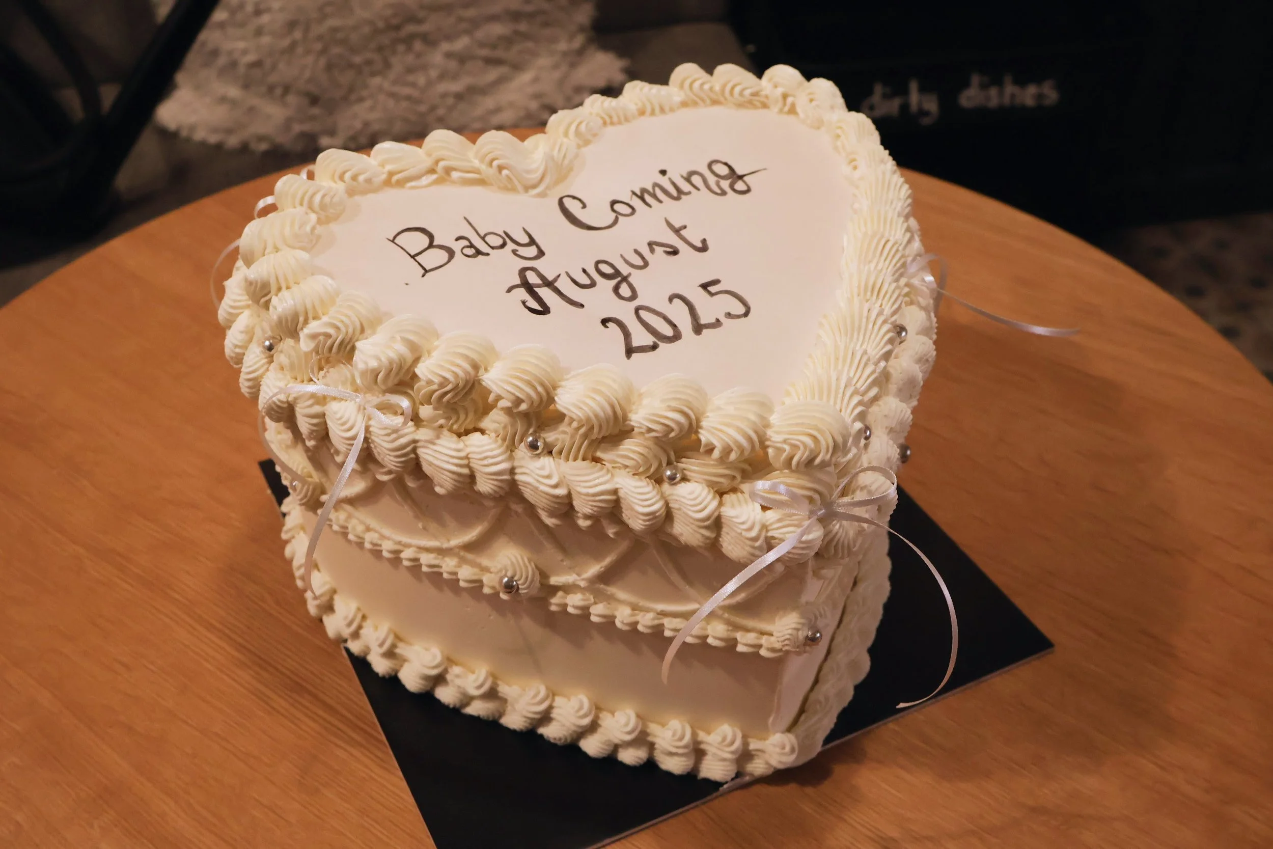 Heart shaped gender reveal cake with vintage piping pearls and bows