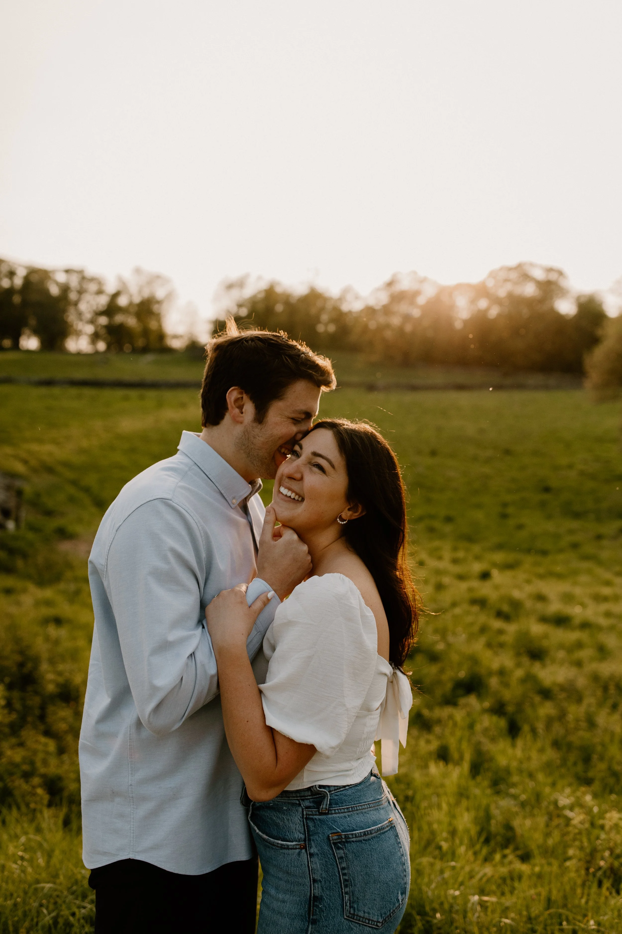 A couple posing for their engagement photos during sunset at a park in Tarrytown NY