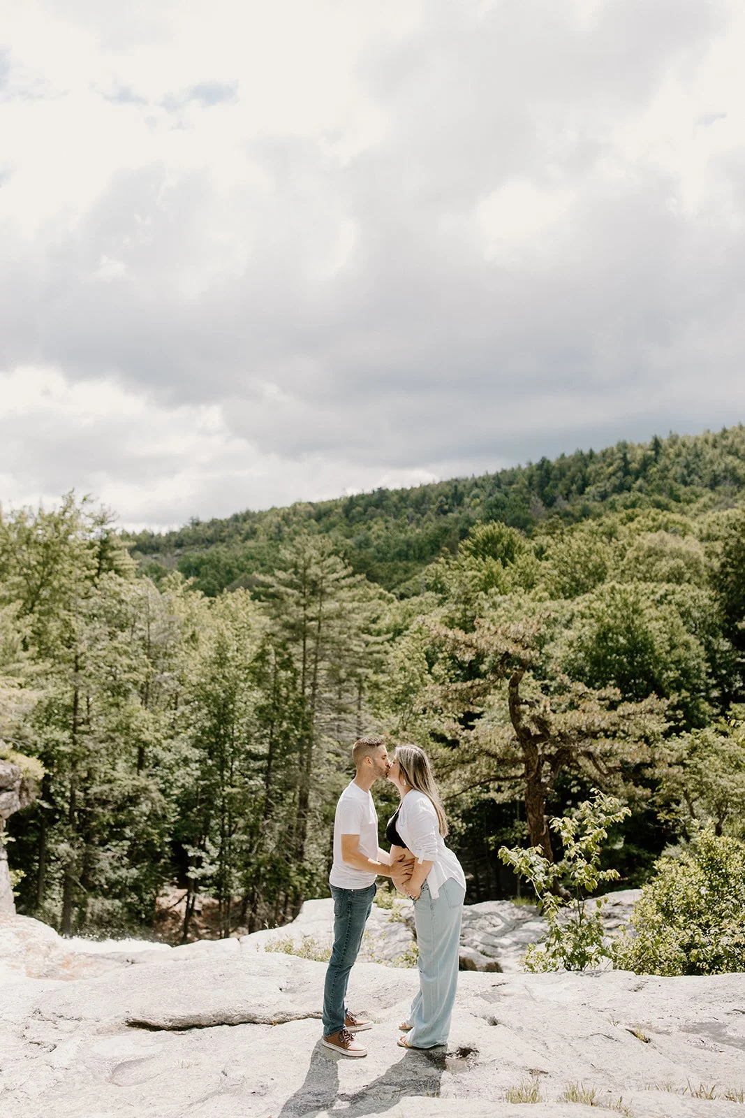 A couple posing for their maternity photos. Photos being taken at Awosting Falls.