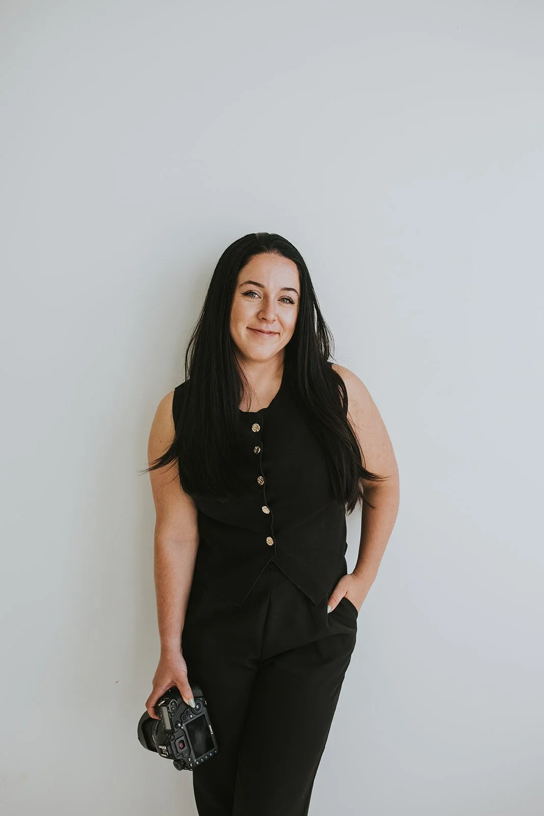 A photographer poses for her picture to be taken at a studio in Wappingers NY